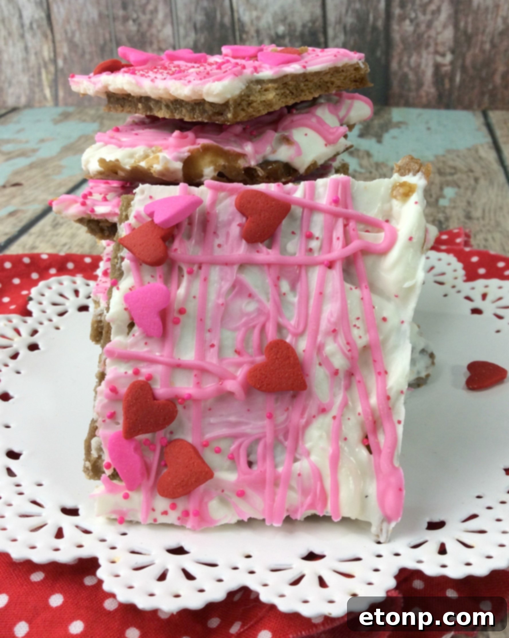 A close-up of individual pieces of Valentine's Day Crack, showing the layers of graham cracker and chocolate.