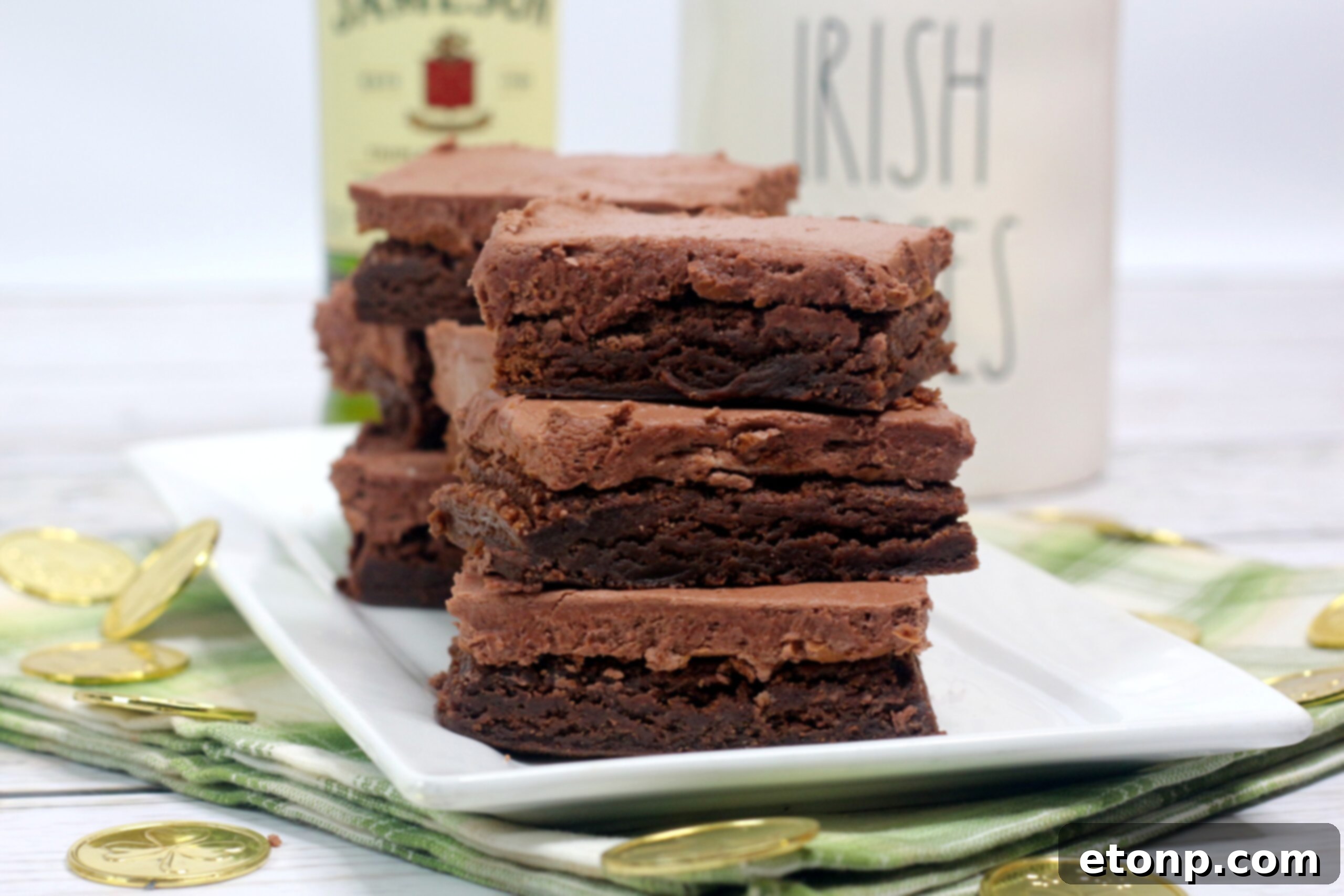 A freshly baked batch of Irish fudge brownies, generously covered in a thick layer of chocolate whiskey buttercream frosting.