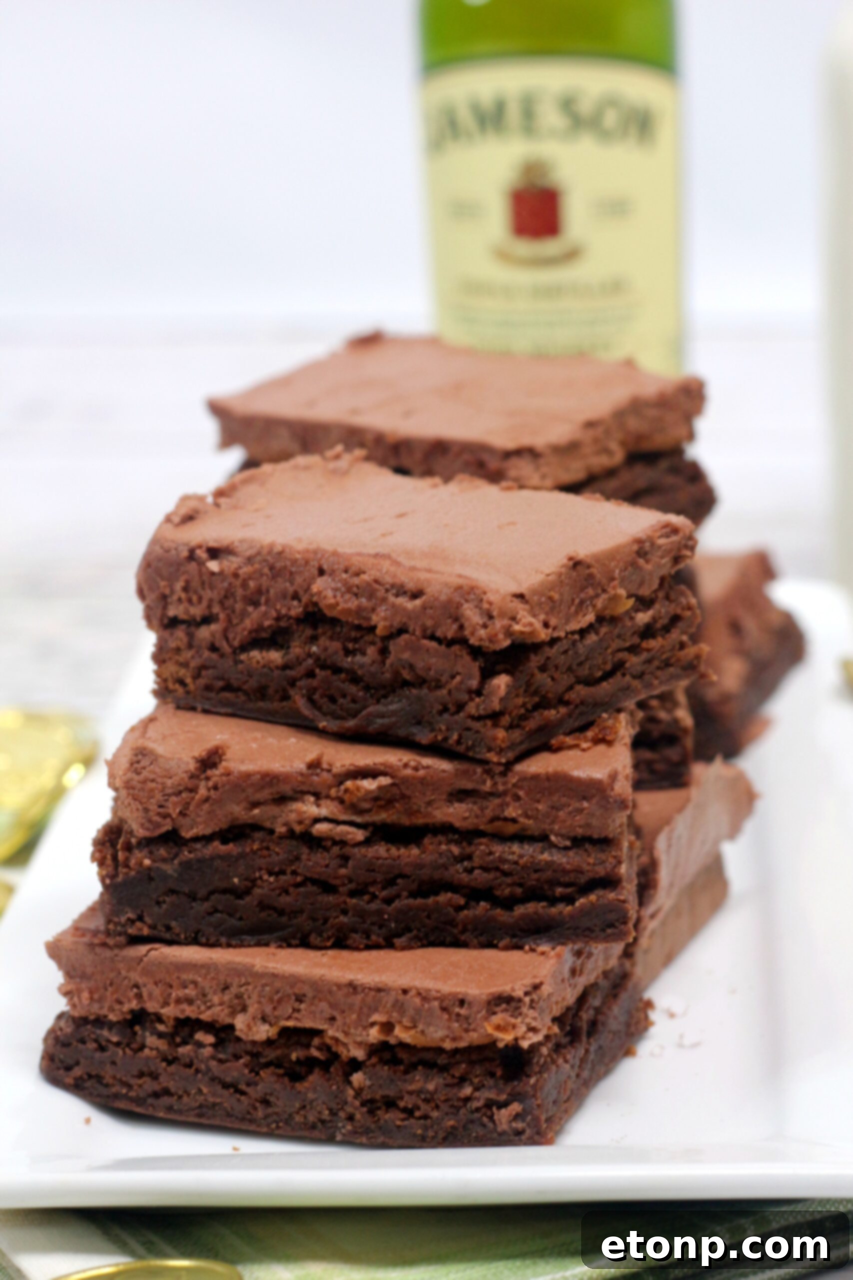 Individual Irish fudge brownies with chocolate whiskey frosting, perfectly cut and ready for serving.