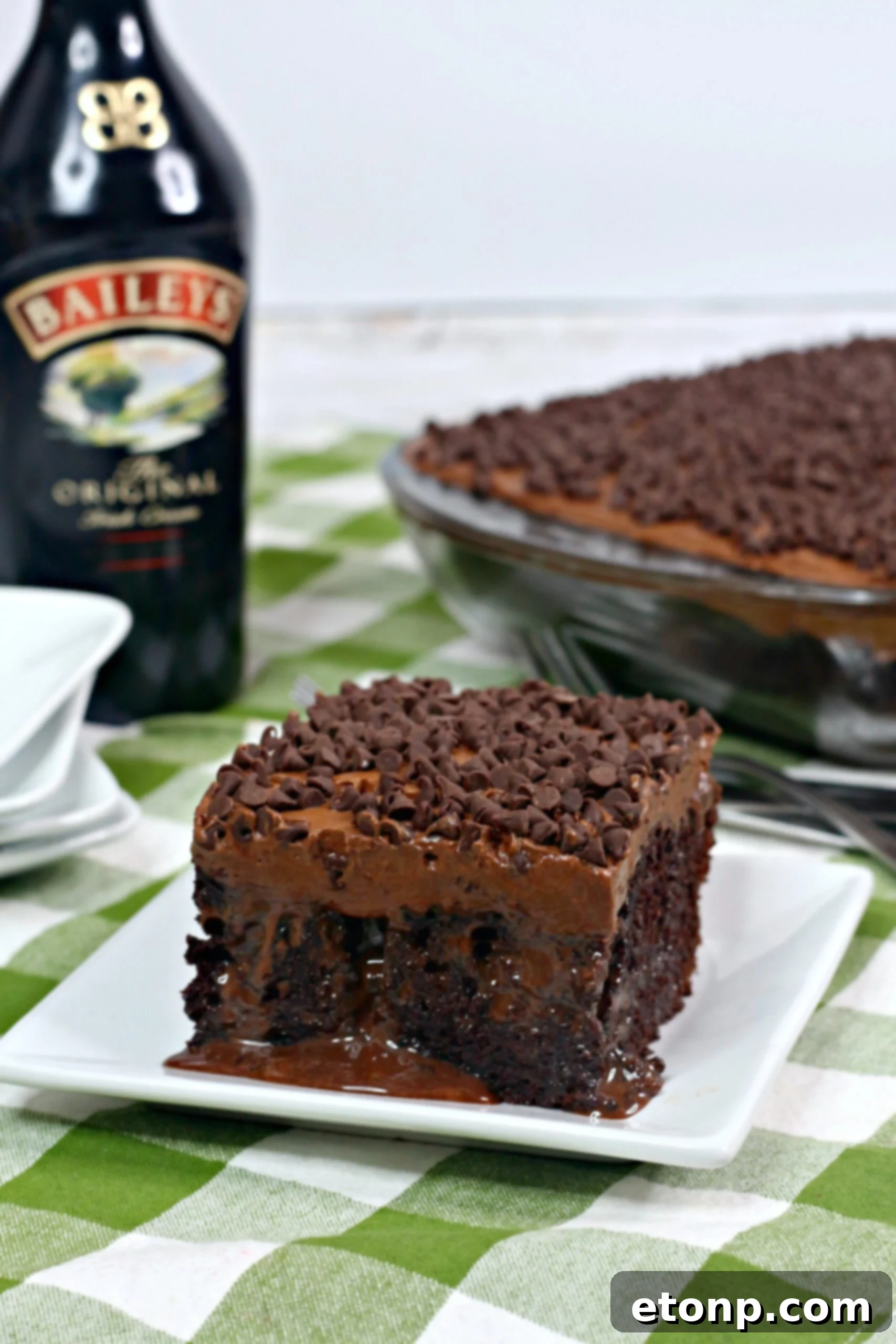 A slice of Baileys Irish Cream Chocolate Cake with a fork, ready to be enjoyed