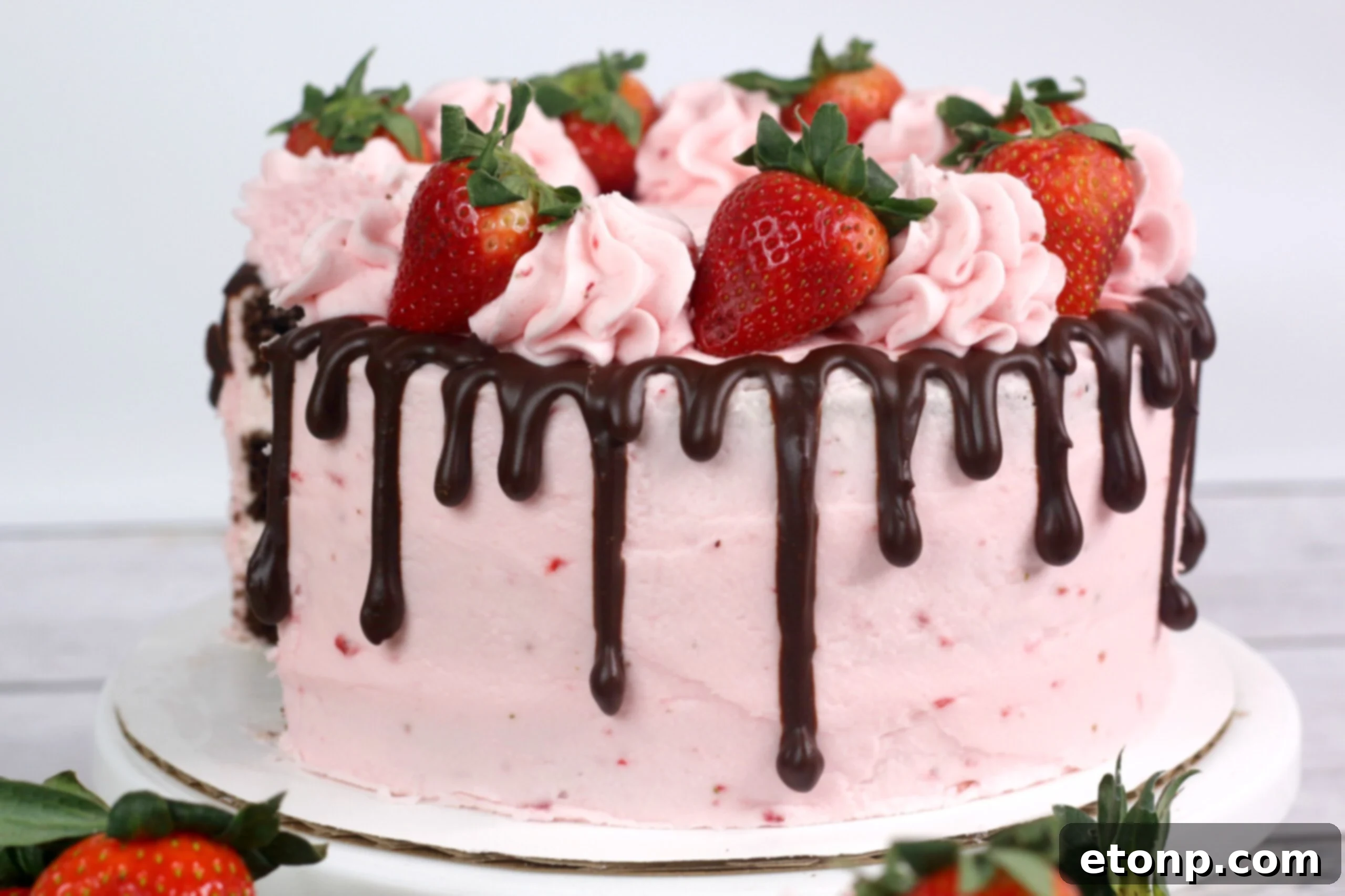 Close-up of the top of the Chocolate Kahlua Cake with ganache drizzle and fresh strawberries