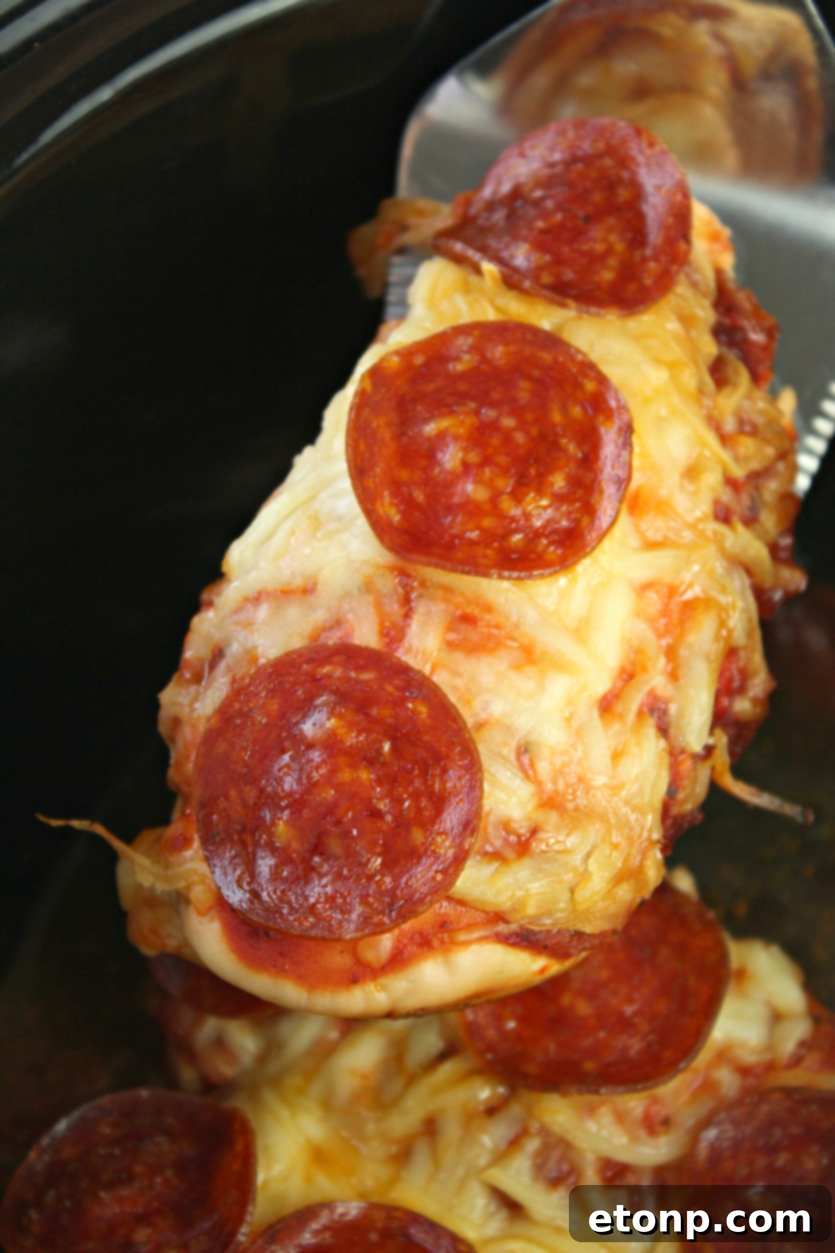 Close-up of Slow Cooker Pizza Chicken with melted cheese and pepperoni