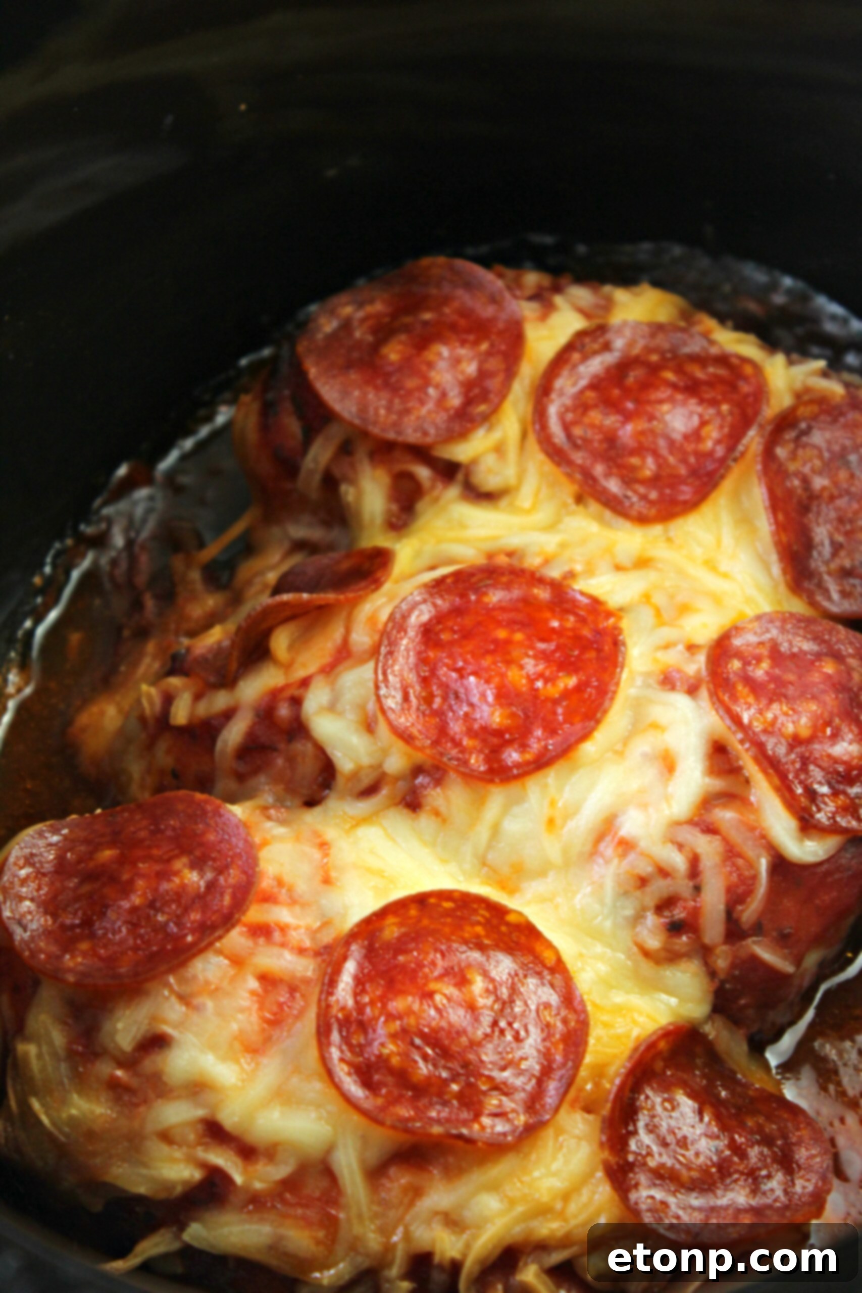 A serving of Slow Cooker Pizza Chicken with salad and wine