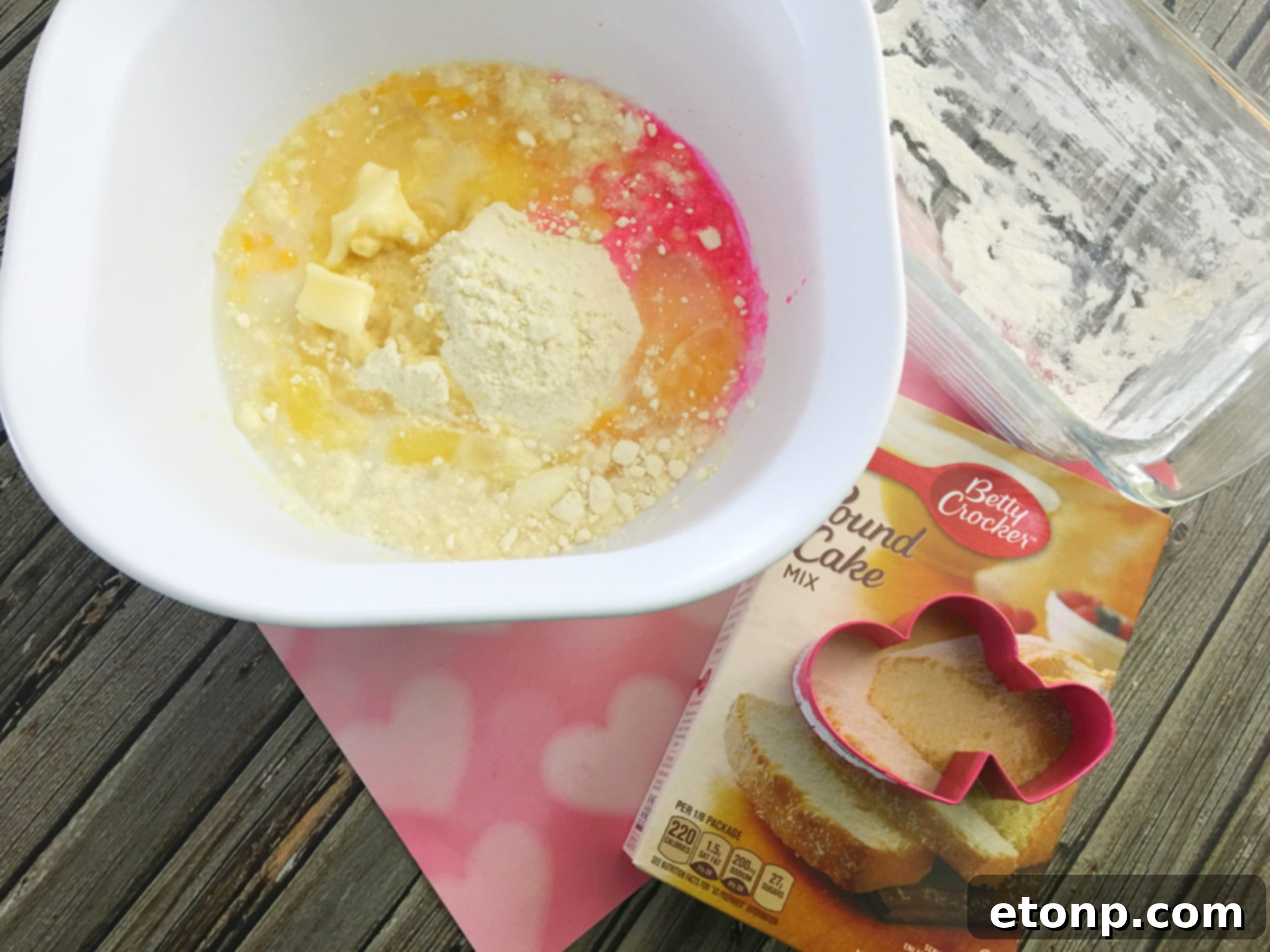 Cream cheese being added to pound cake batter