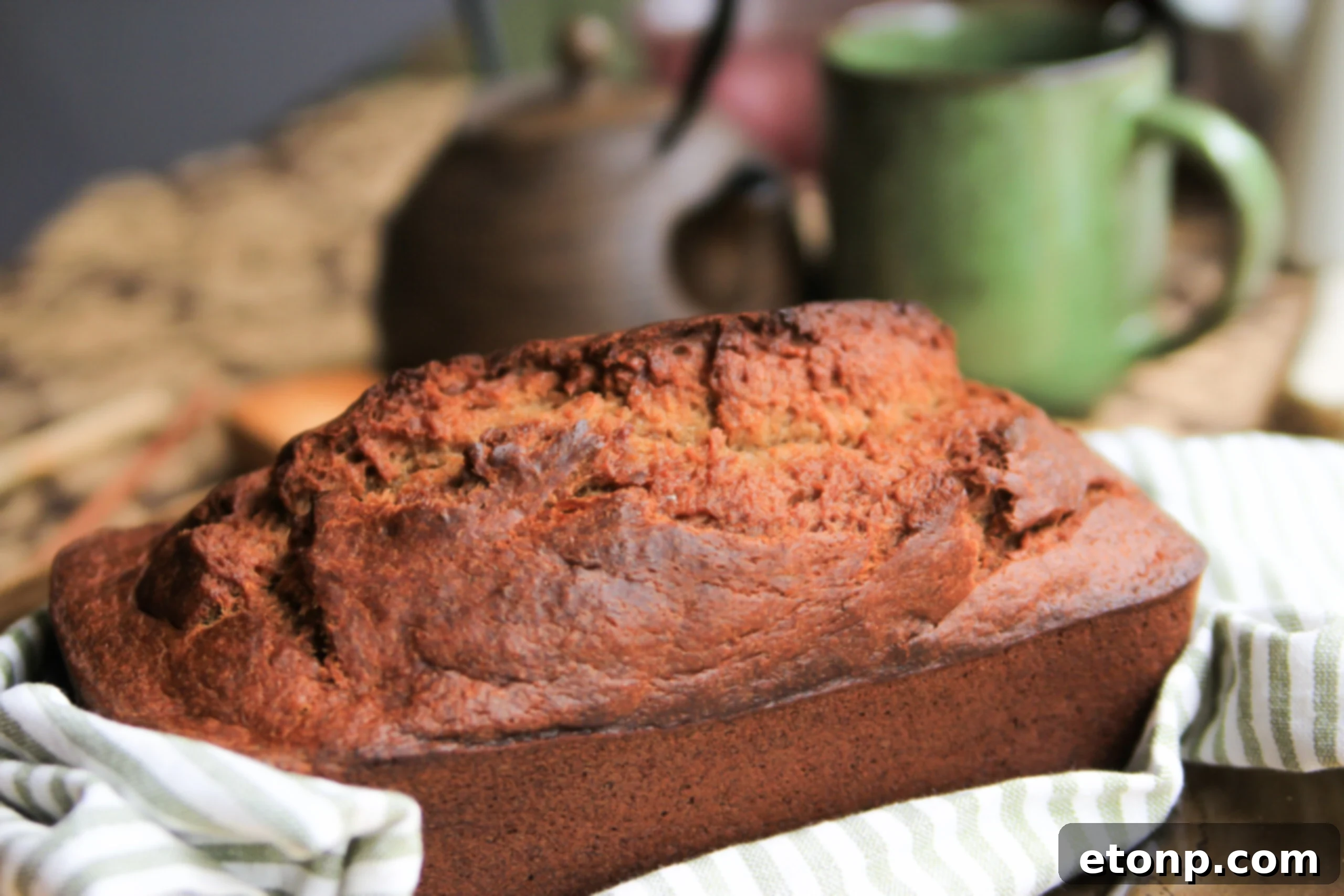 Several slices of freshly baked banana bread arranged on a wooden board, highlighting their golden color and inviting texture.