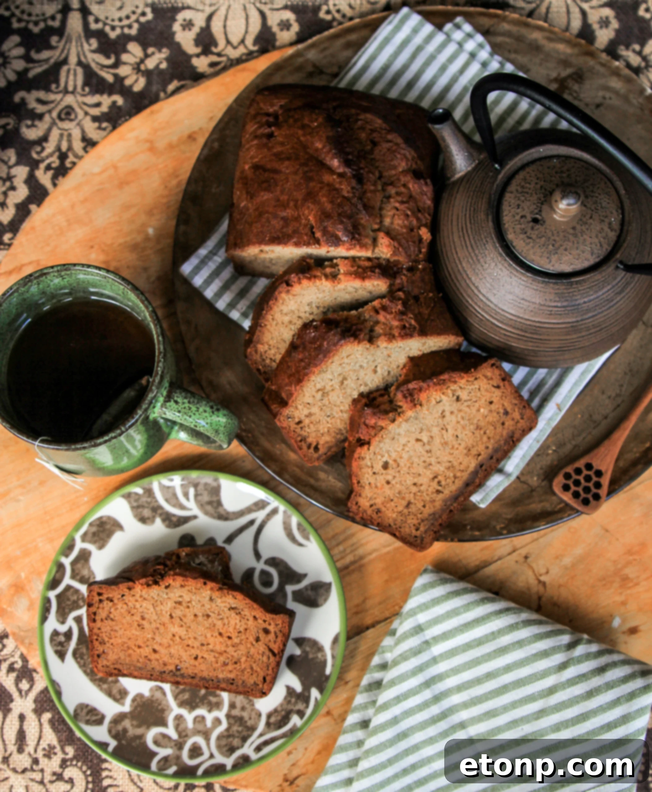 Several slices of rich, dark banana bread on a light-colored plate, highlighting its dense, moist texture and inviting aroma.