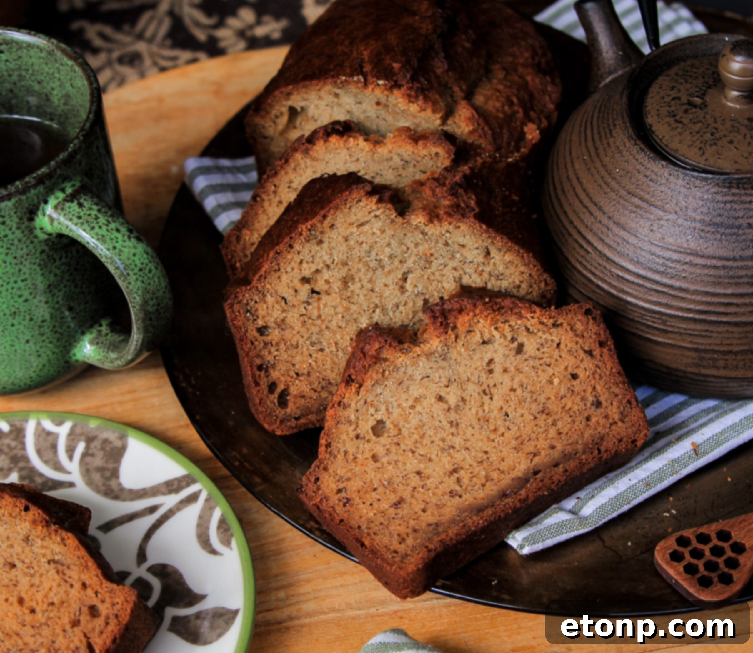 An entire loaf of golden brown banana bread, just out of the oven, sitting on a cooling rack, filling the kitchen with its sweet scent.