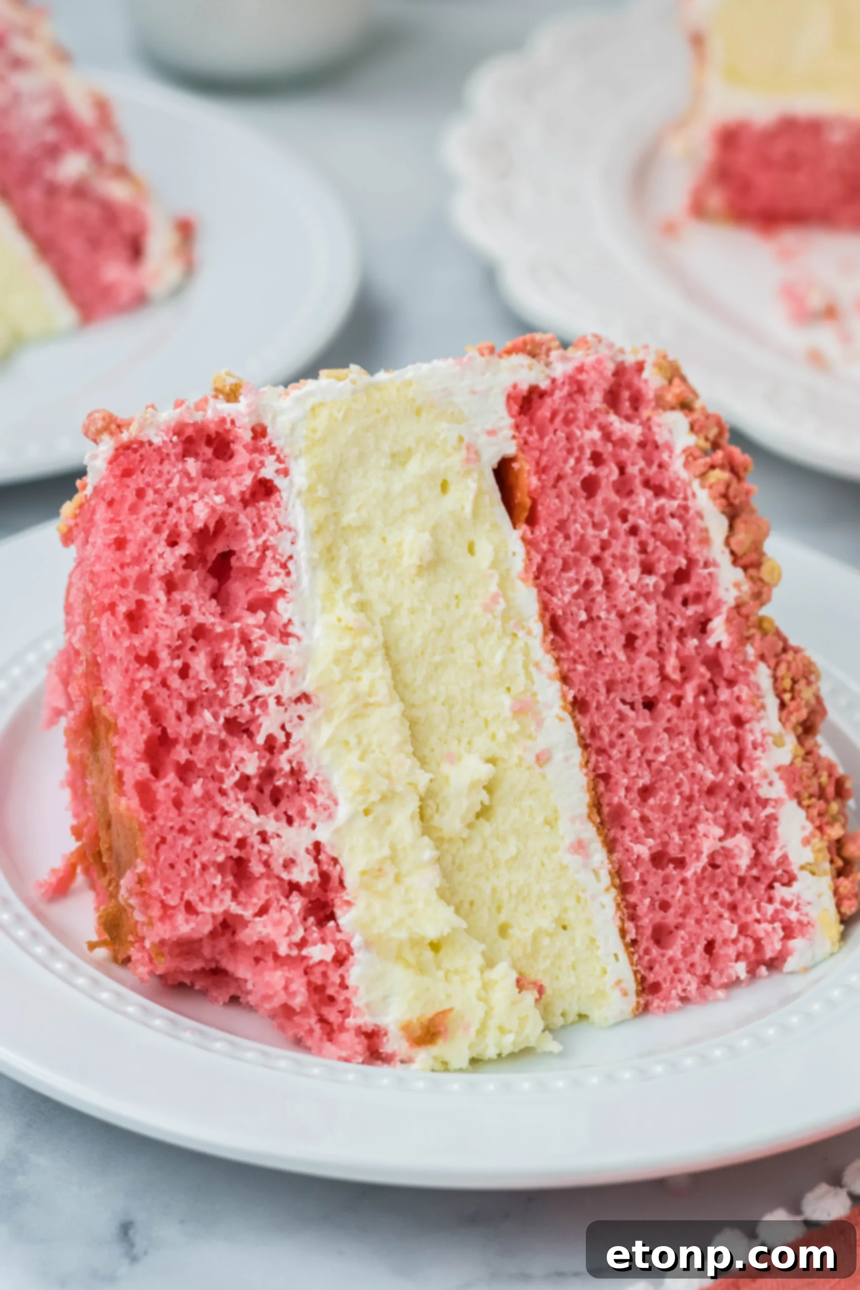 Strawberry Shortcake Cheesecake Cake slice on a white plate