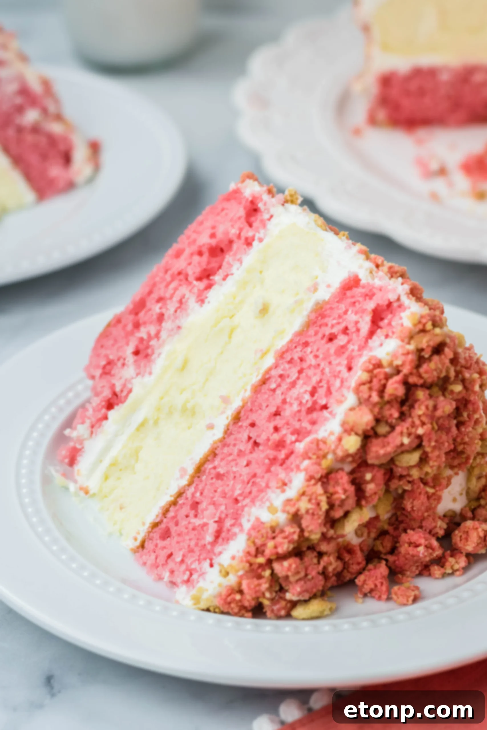 slide angle shot of the Strawberry Shortcake Cheesecake Cake on a white plate 