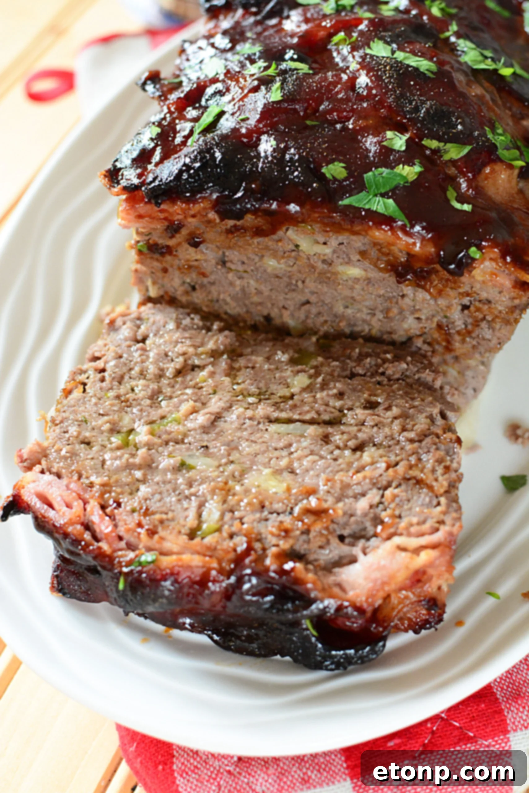 Caramelized Bacon Meatloaf 7 A close-up of the delicious texture and glaze of a candied bacon wrapped meatloaf.