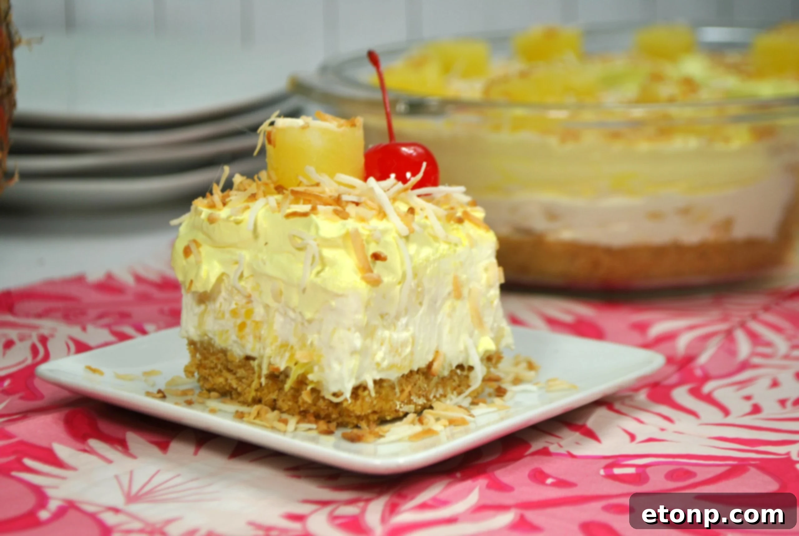 Close-up of a slice of No Bake Pineapple Dream Dessert, showing layers