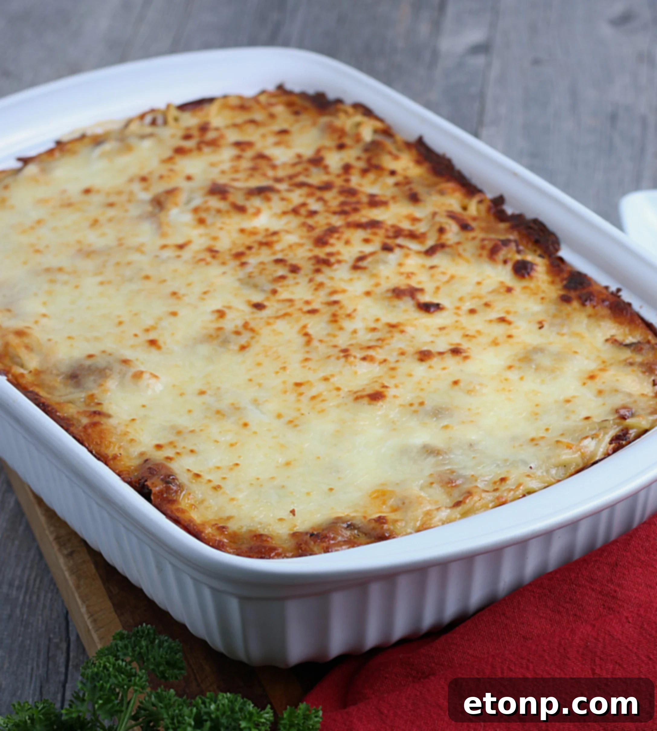 Rich Beef and Melted Cheese Baked Spaghetti 4 A dish of baked spaghetti ready to be served, showing golden crust