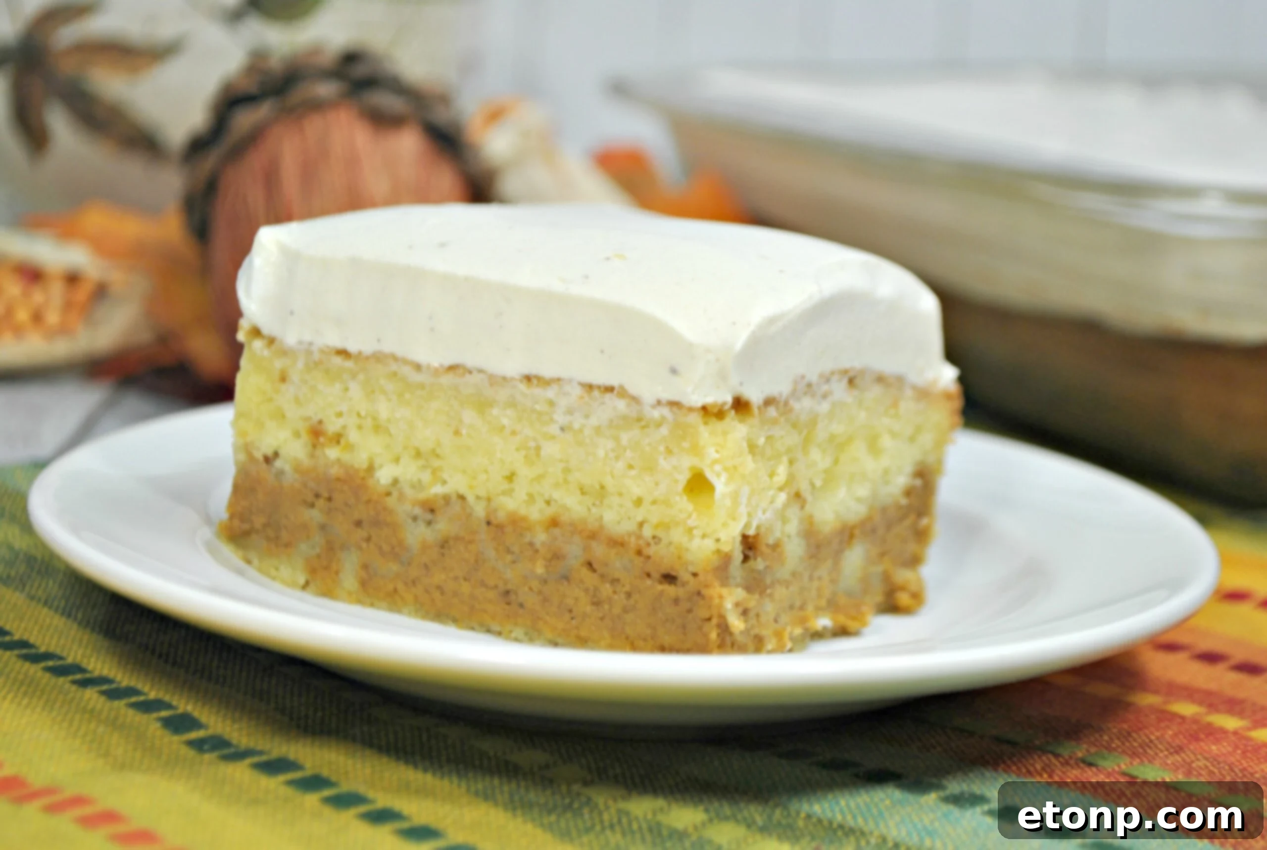 Enchanted Harvest Pumpkin Cake 4 A slice of Pumpkin Magic Cake with thick vanilla cream cheese frosting