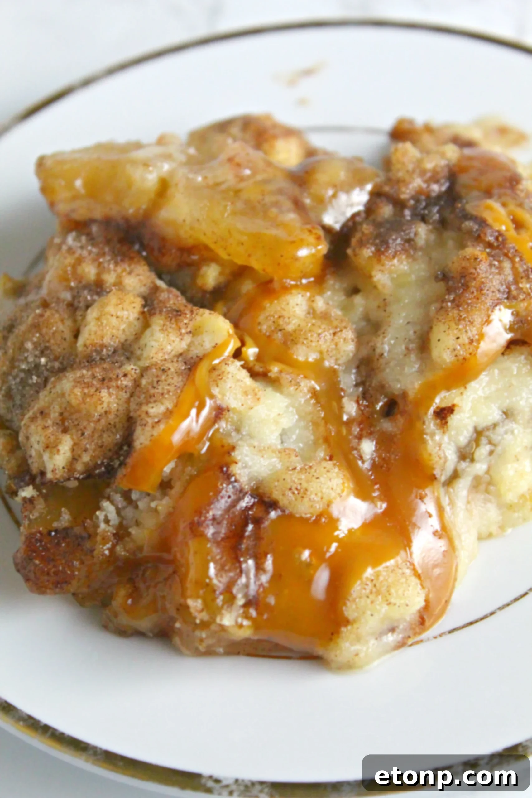 Another angle of the warm Snickerdoodle Cobbler in a baking dish, served with ice cream.
