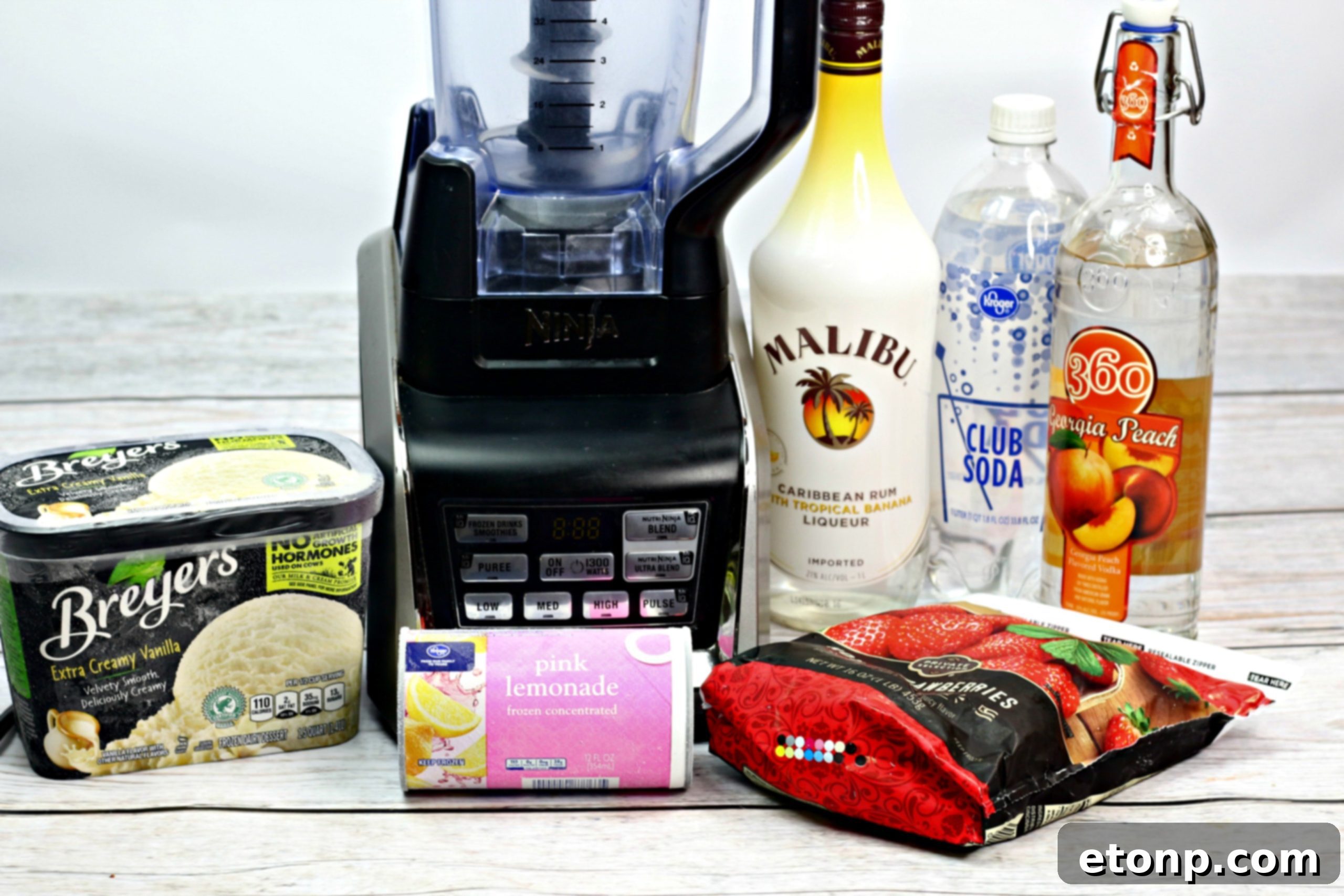 Ingredients laid out for Pink Panties Cocktail preparation, highlighting frozen lemonade, peach vodka, and Malibu rum