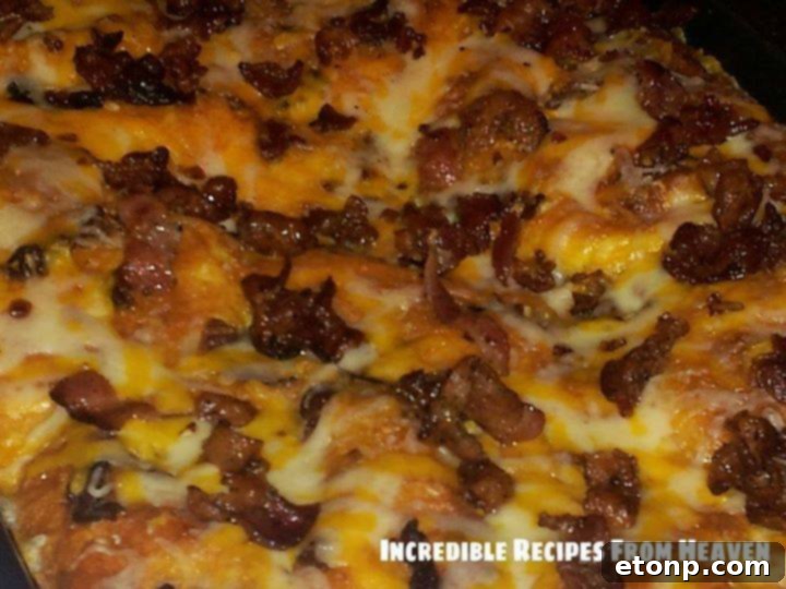 Perfect Sunday Bacon, Egg, and Cheese Biscuit Bake 3 Close-up of fluffy biscuits coated in egg mixture