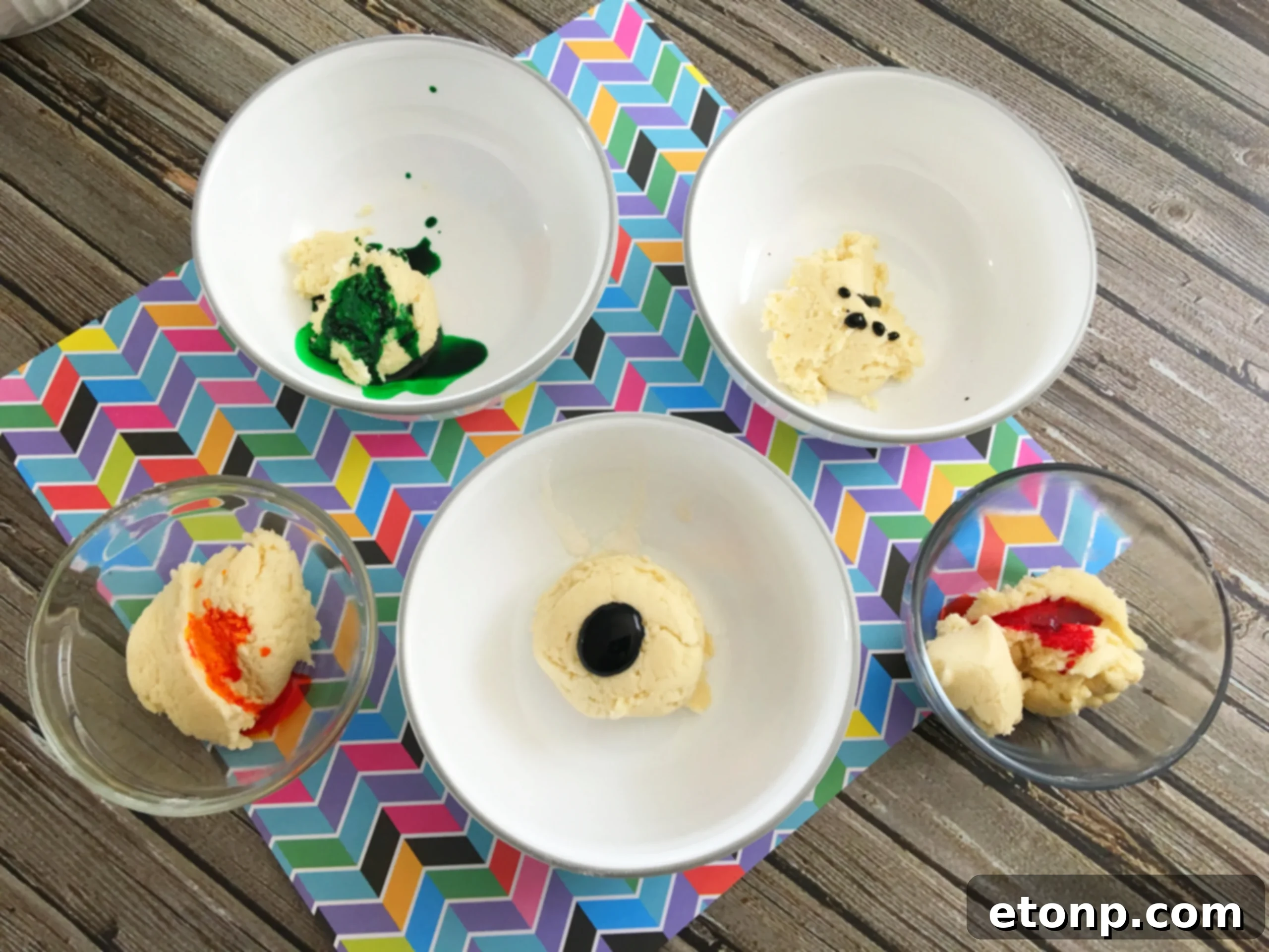 Children's hands joyfully shaping rainbow cookie dough, showing the vibrant colors before baking