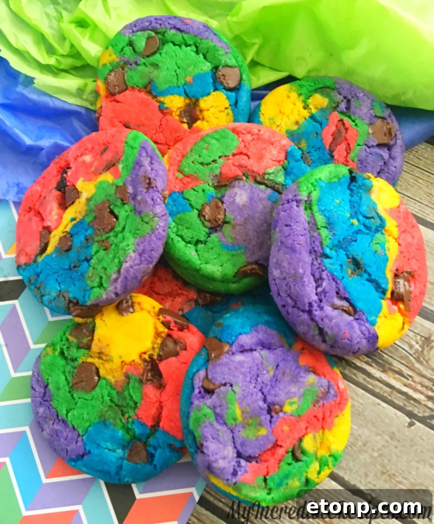 Close-up of a single rainbow chocolate chip cookie, perfectly baked and showcasing its colorful layers and melted chocolate chips