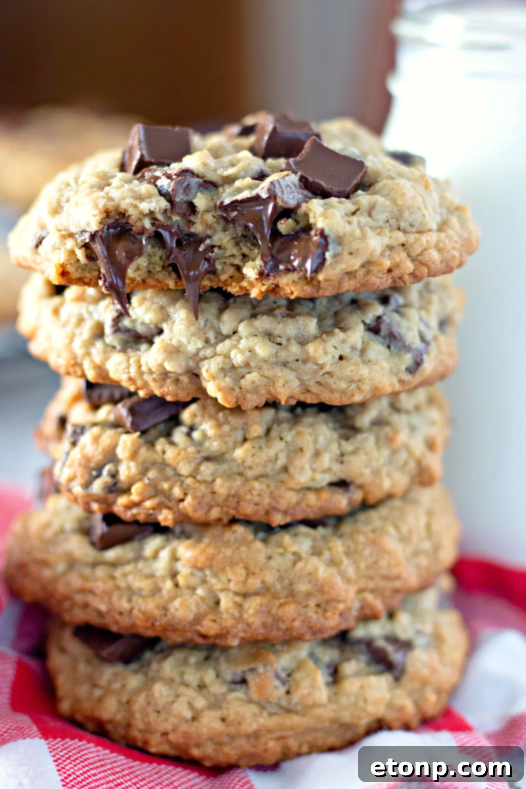 Chewy Jumbo Chocolate Chunk Oat Cookies 2 A stack of golden brown giant chocolate chunk oatmeal cookies