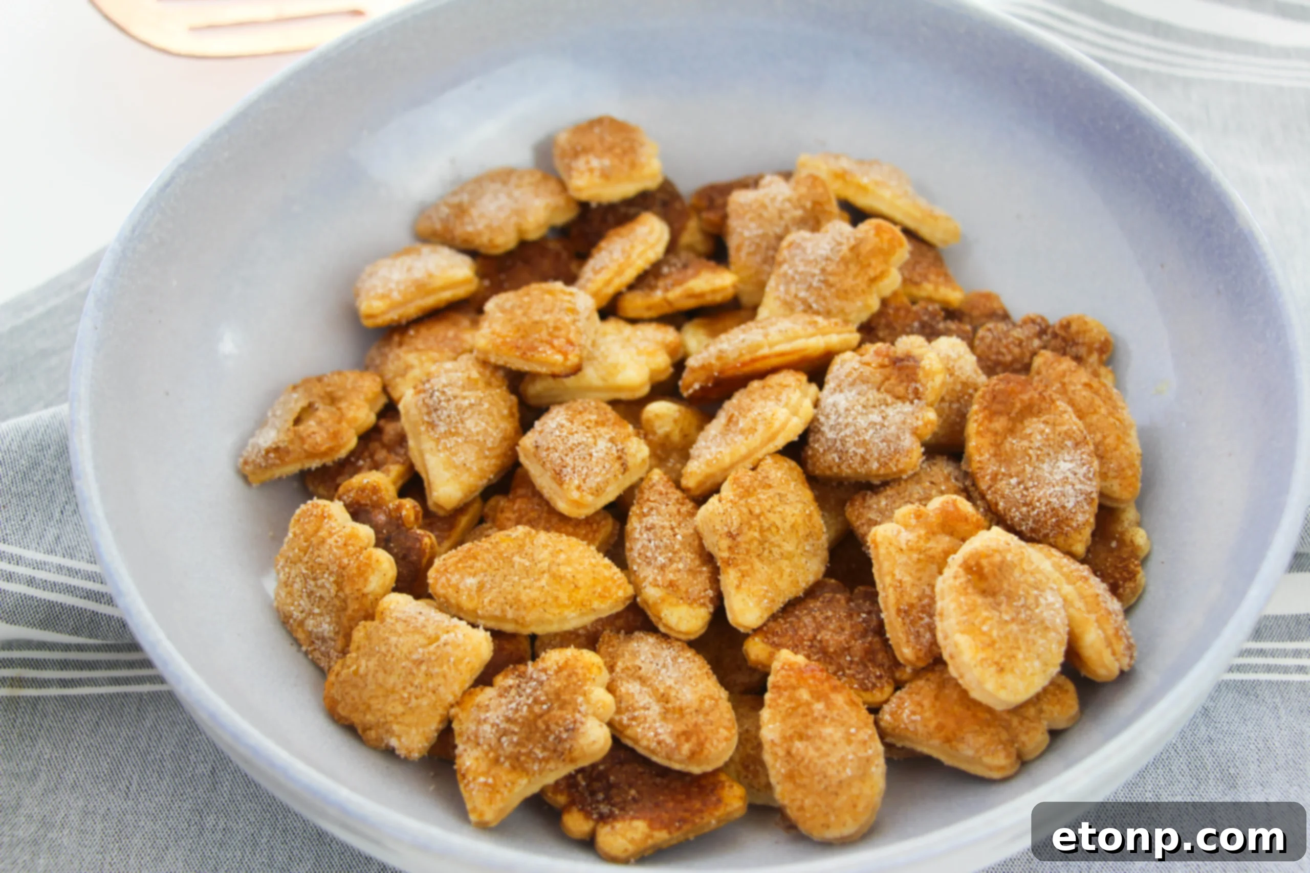 A close-up of Snickerdoodle Pie Crust Cookies, showing their perfect golden-brown color and cinnamon-sugar topping