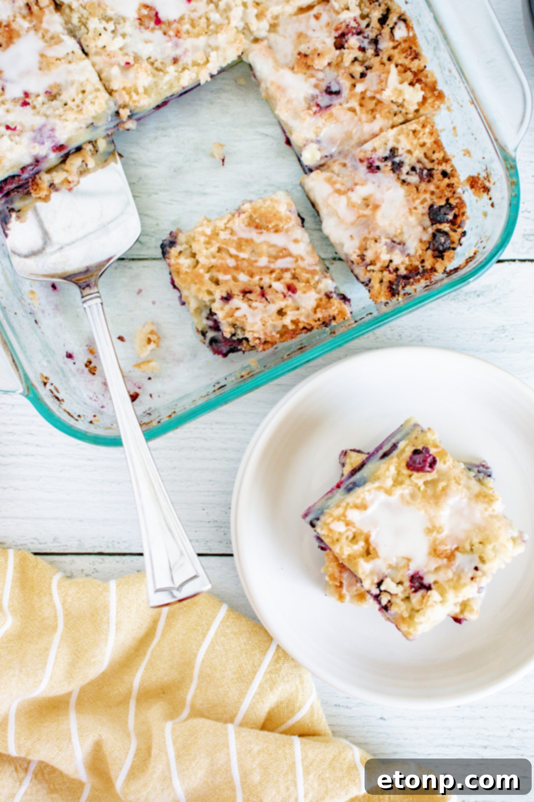 Overhead shot of the entire blueberry muffin cake with a golden streusel crust and white vanilla glaze