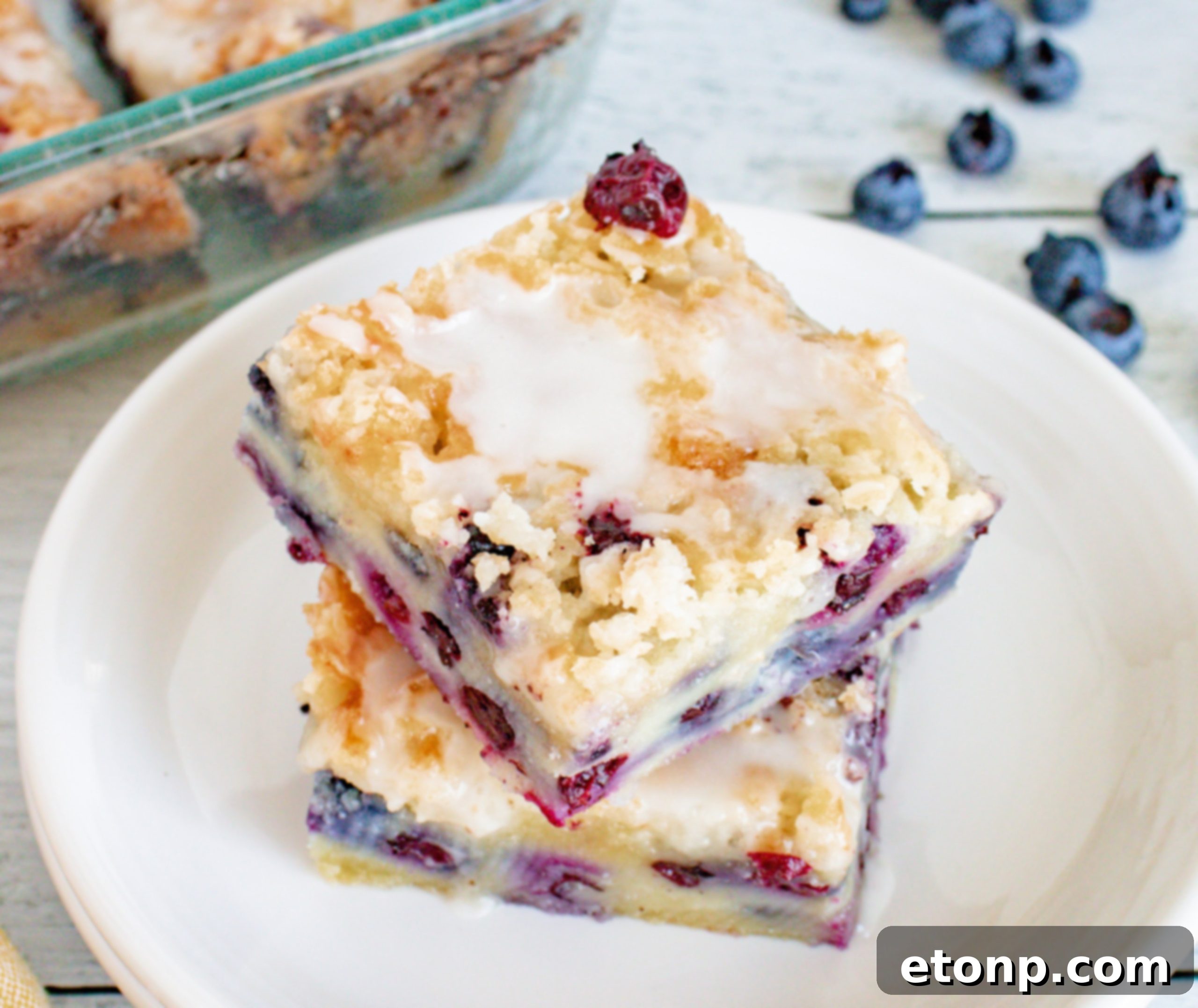 A close-up of the blueberry muffin cake being served, showing the moist interior and plentiful blueberries