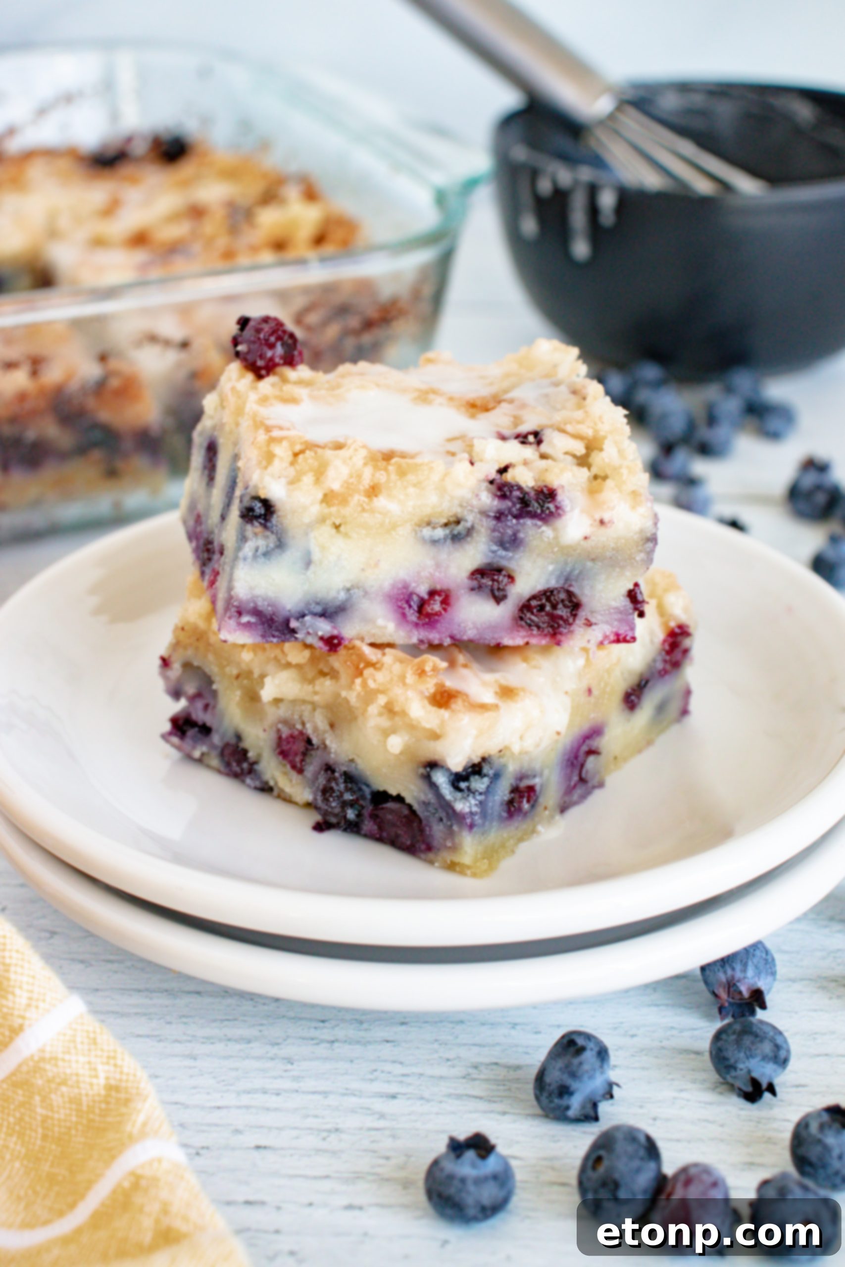 Blueberry muffin cake in a square baking pan, ready to be cut and served