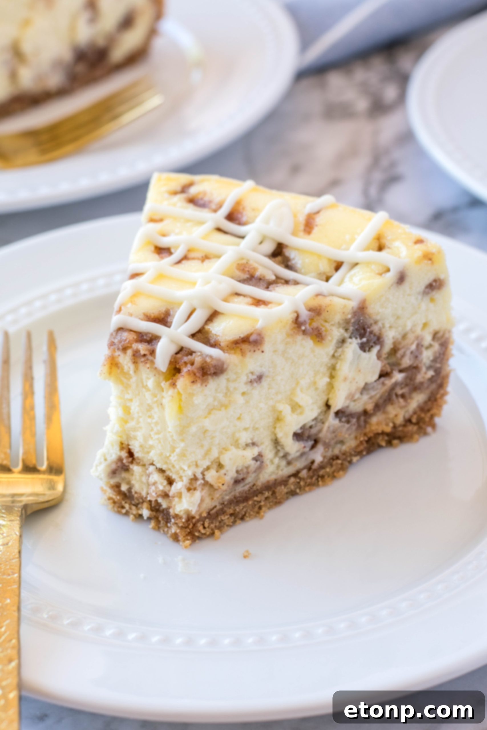 Another perspective of the Cinnamon Roll Cheesecake, highlighting its inviting golden-brown crumble topping.