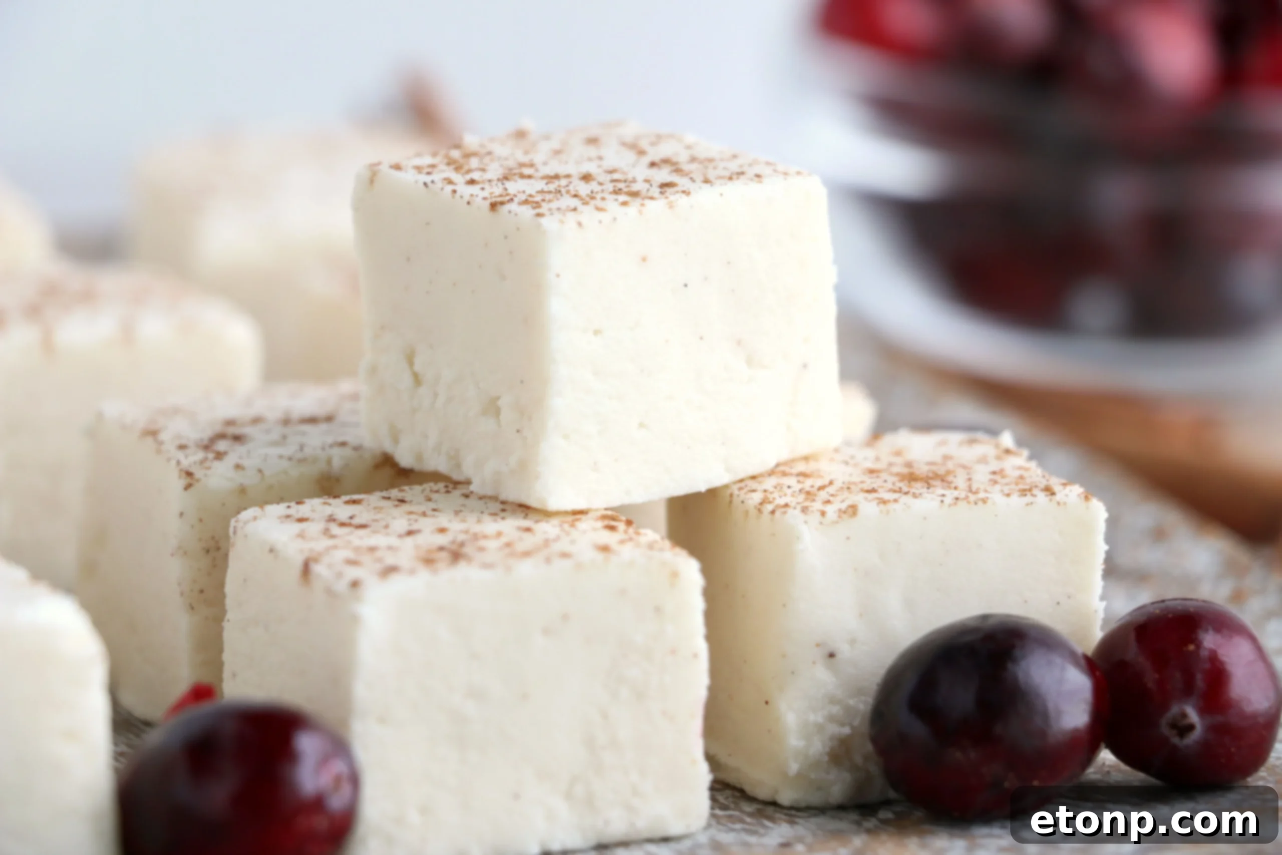 A plate of eggnog fudge squares arranged for serving, showcasing their golden color and inviting texture.