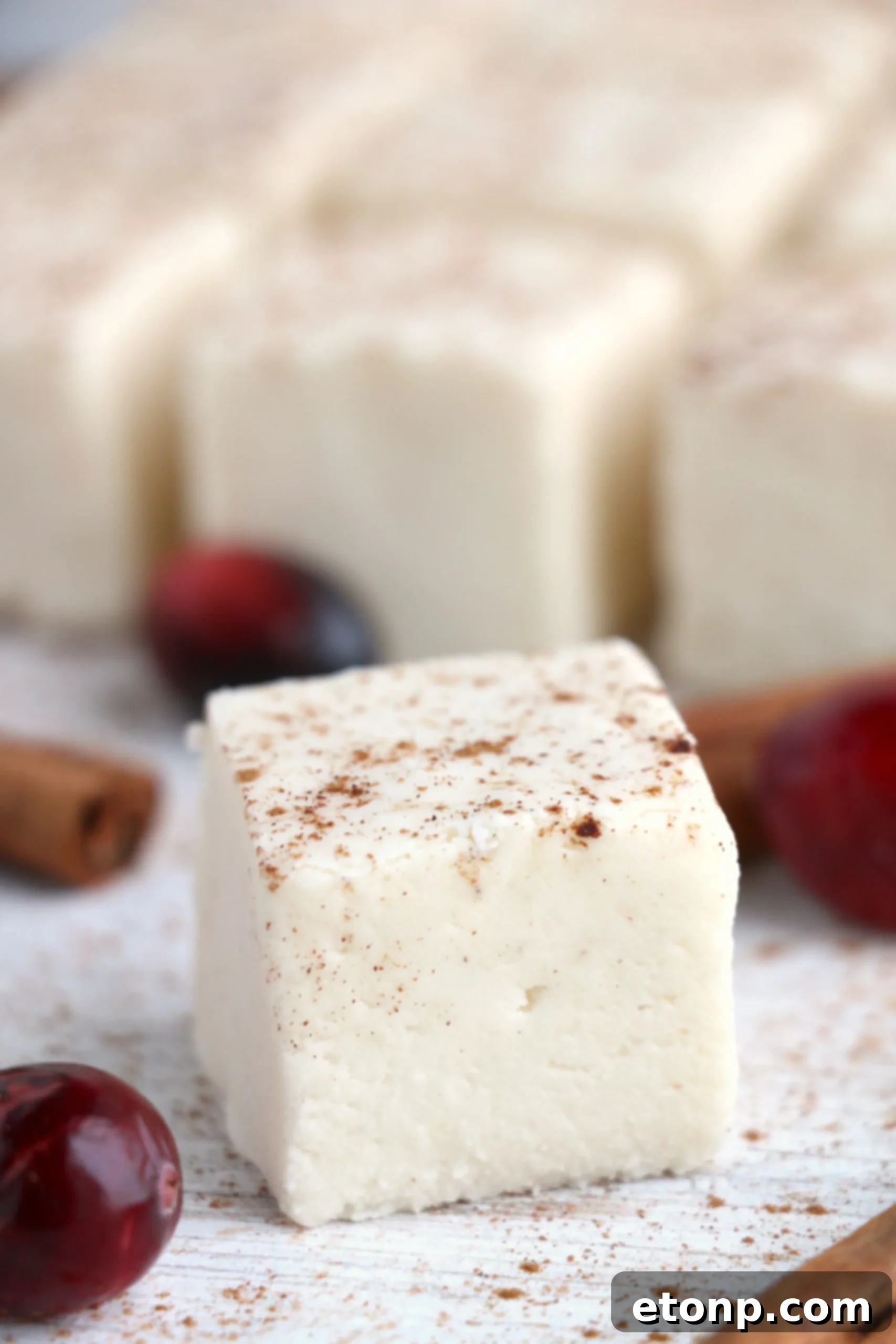 A bowl of eggnog fudge, ready for serving or gifting, with a hint of holiday decorations.