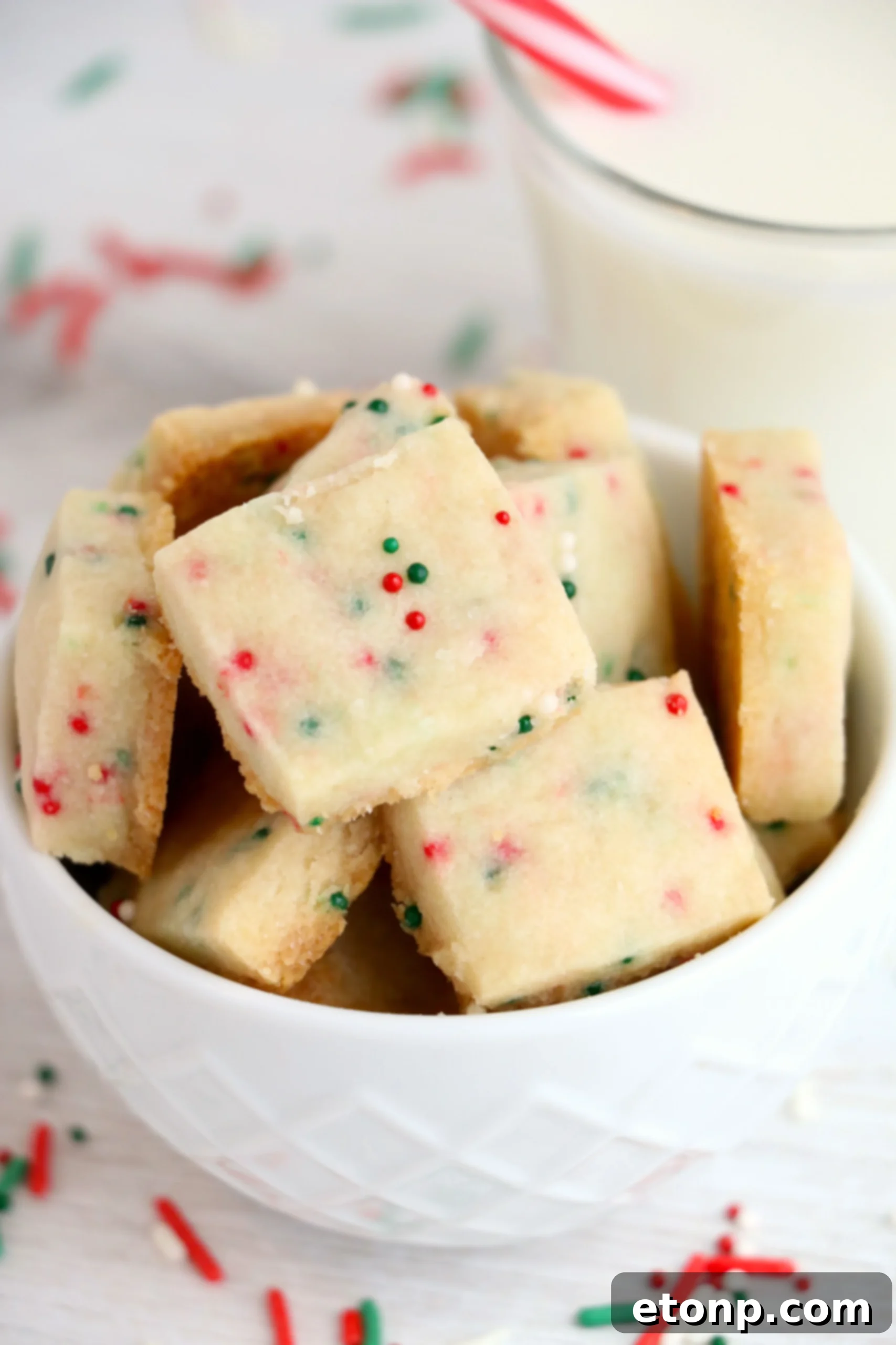 A batch of golden-brown Christmas Shortbread Cookie Bites cooling on a wire rack.