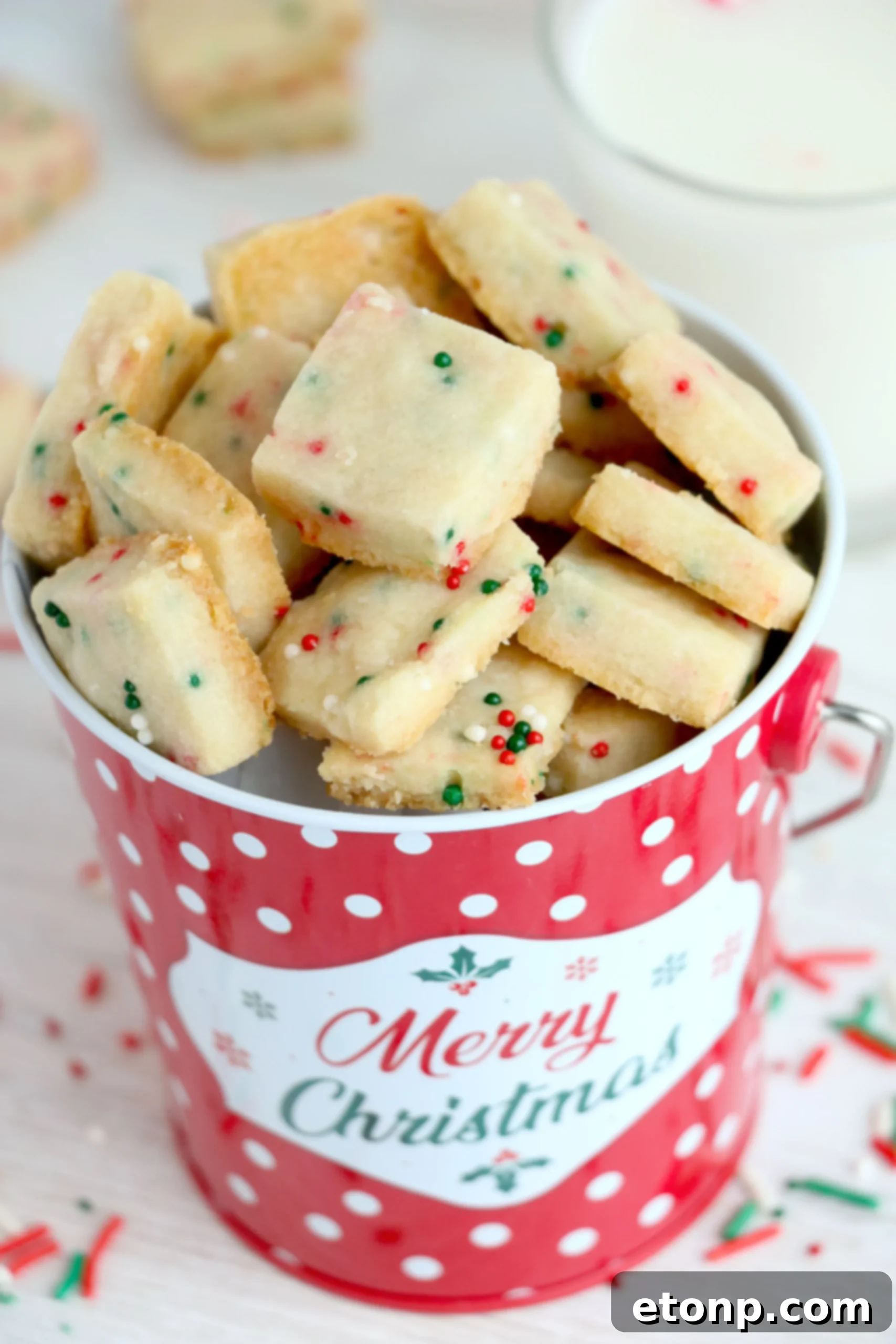 A stack of Christmas Shortbread Cookie Bites on a decorative plate, ready to be served.