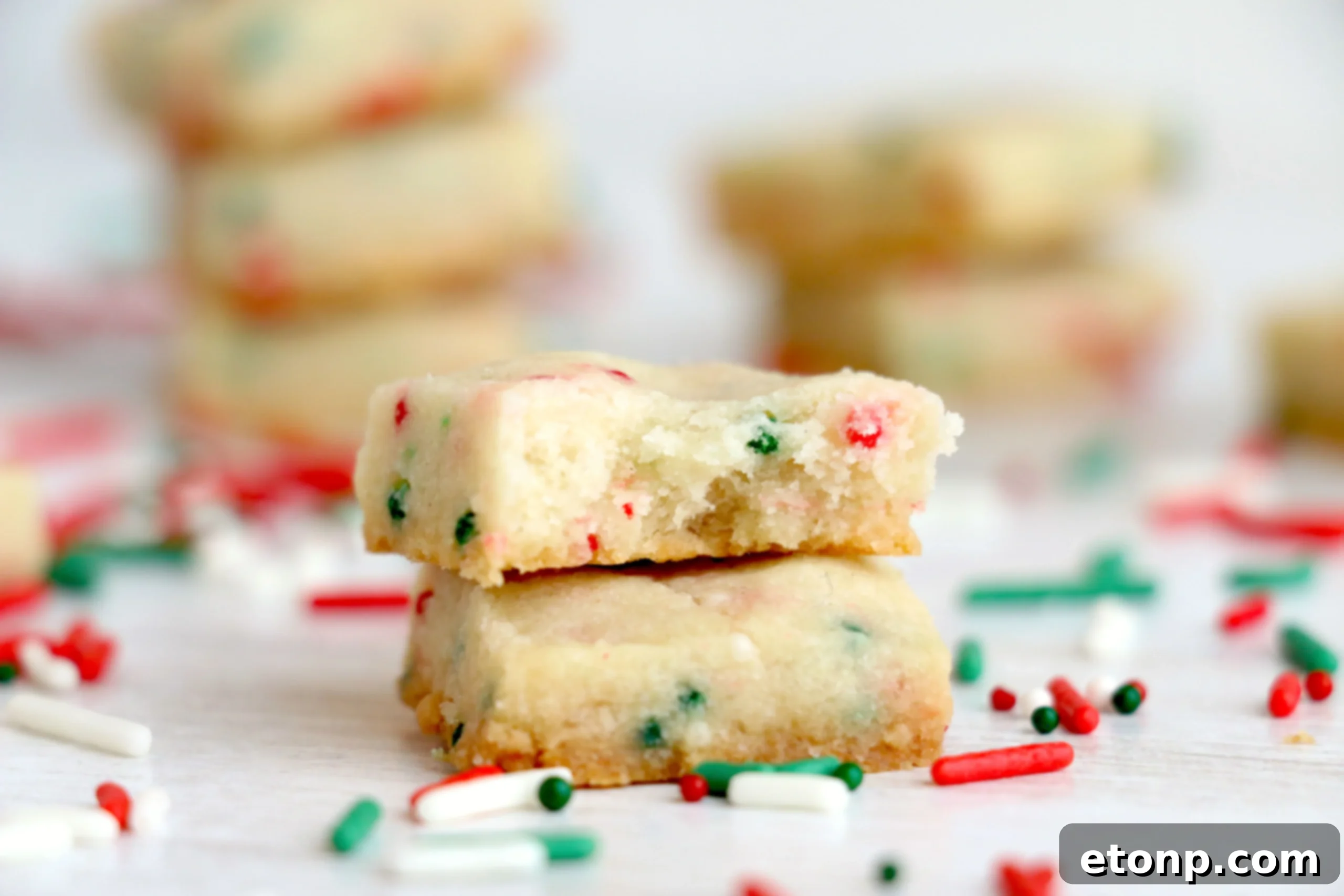 A close-up shot of the golden-brown edges of Christmas Shortbread Cookie Bites.