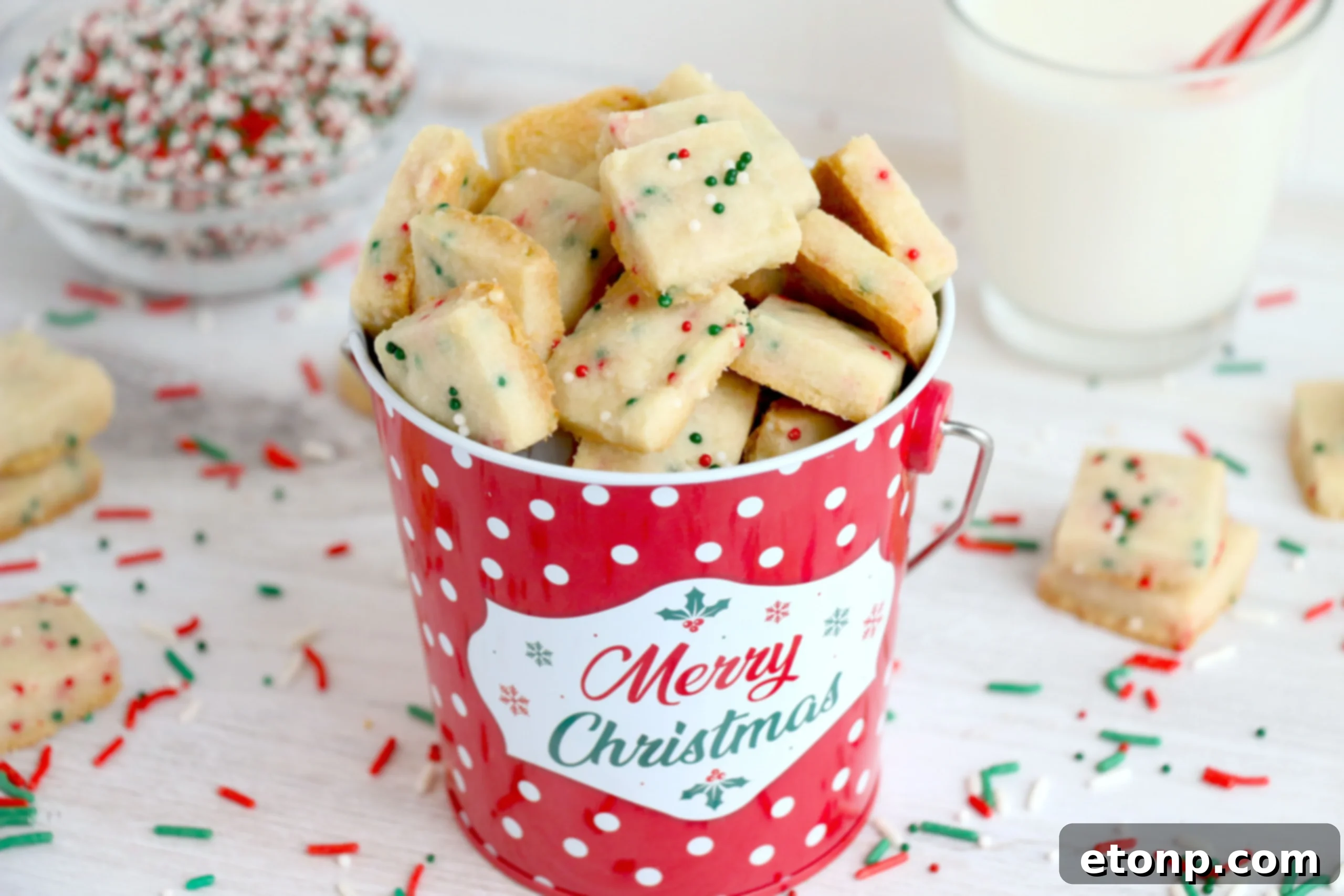 A close-up of a Christmas Shortbread Cookie Bite, showing its crumbly texture and sprinkles.