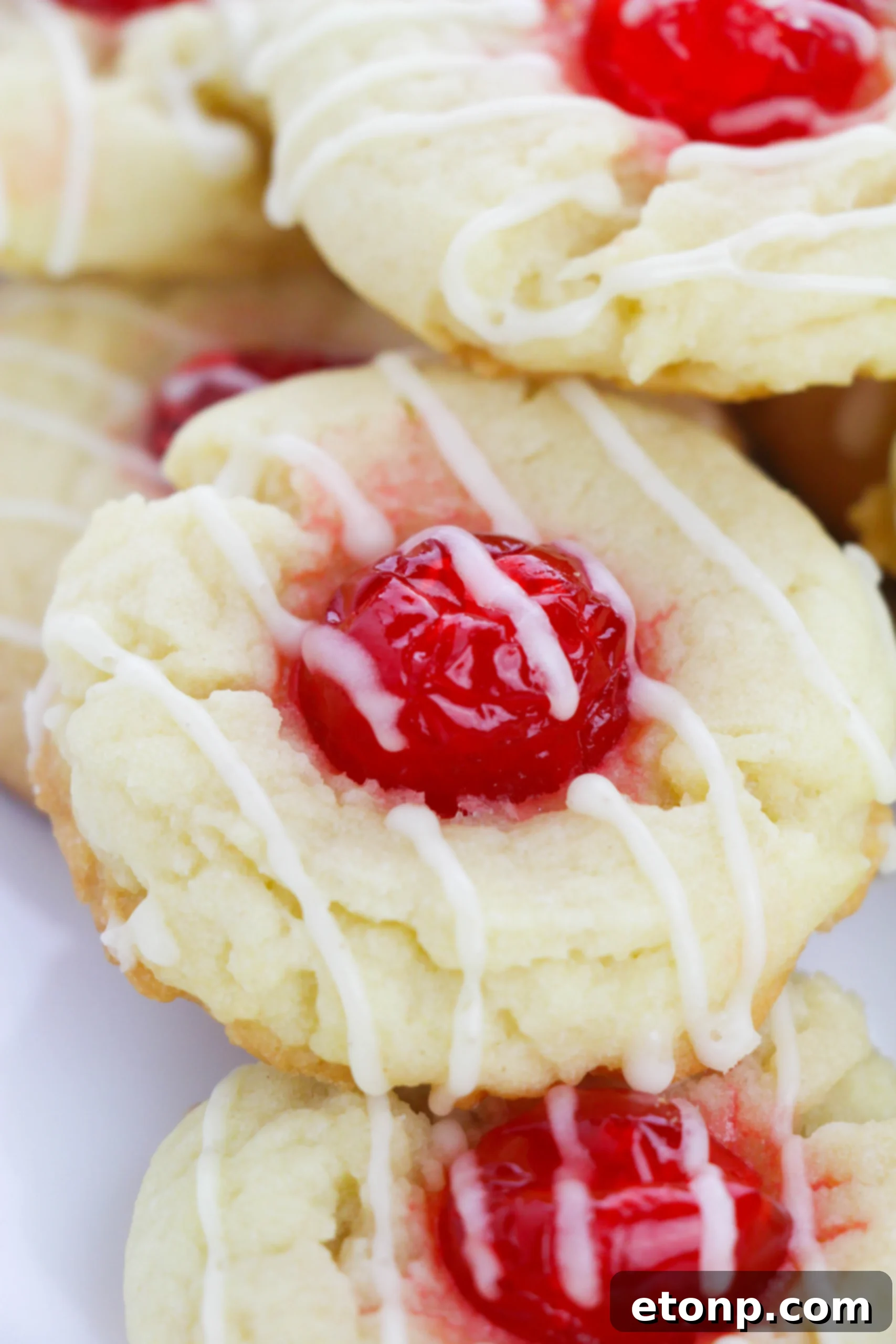 Eggnog Thumbprint Cookies beautifully arranged on a white serving platter, perfect for holiday entertaining.