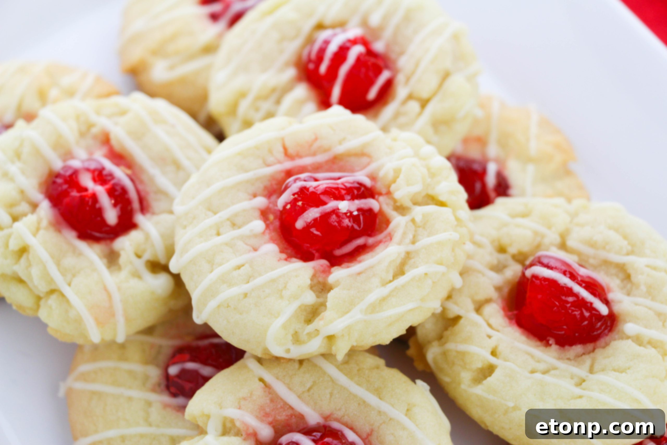 A batch of Eggnog Thumbprint Cookies with icing drizzle, showcasing the delightful texture and festive appeal.