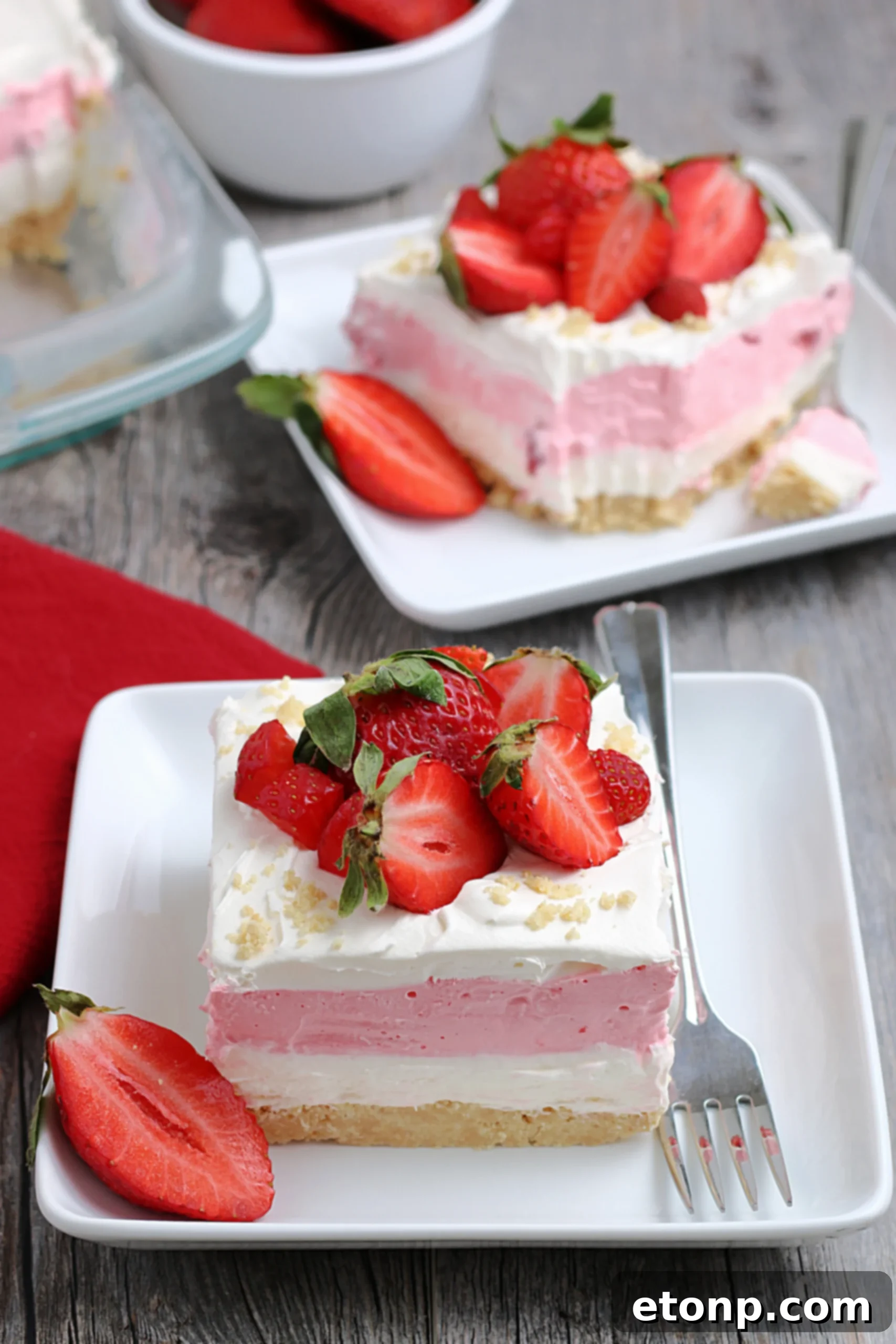 An overhead shot of the full pan of Strawberry Cheesecake Lasagna, highlighting its smooth, even layers and vibrant color.