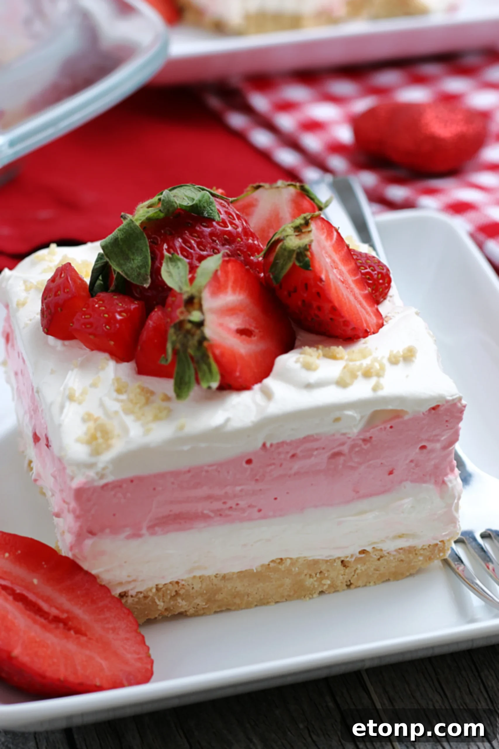 Another perspective of the Strawberry Cheesecake Lasagna, showing the thick layers and the texture of the whipped topping.
