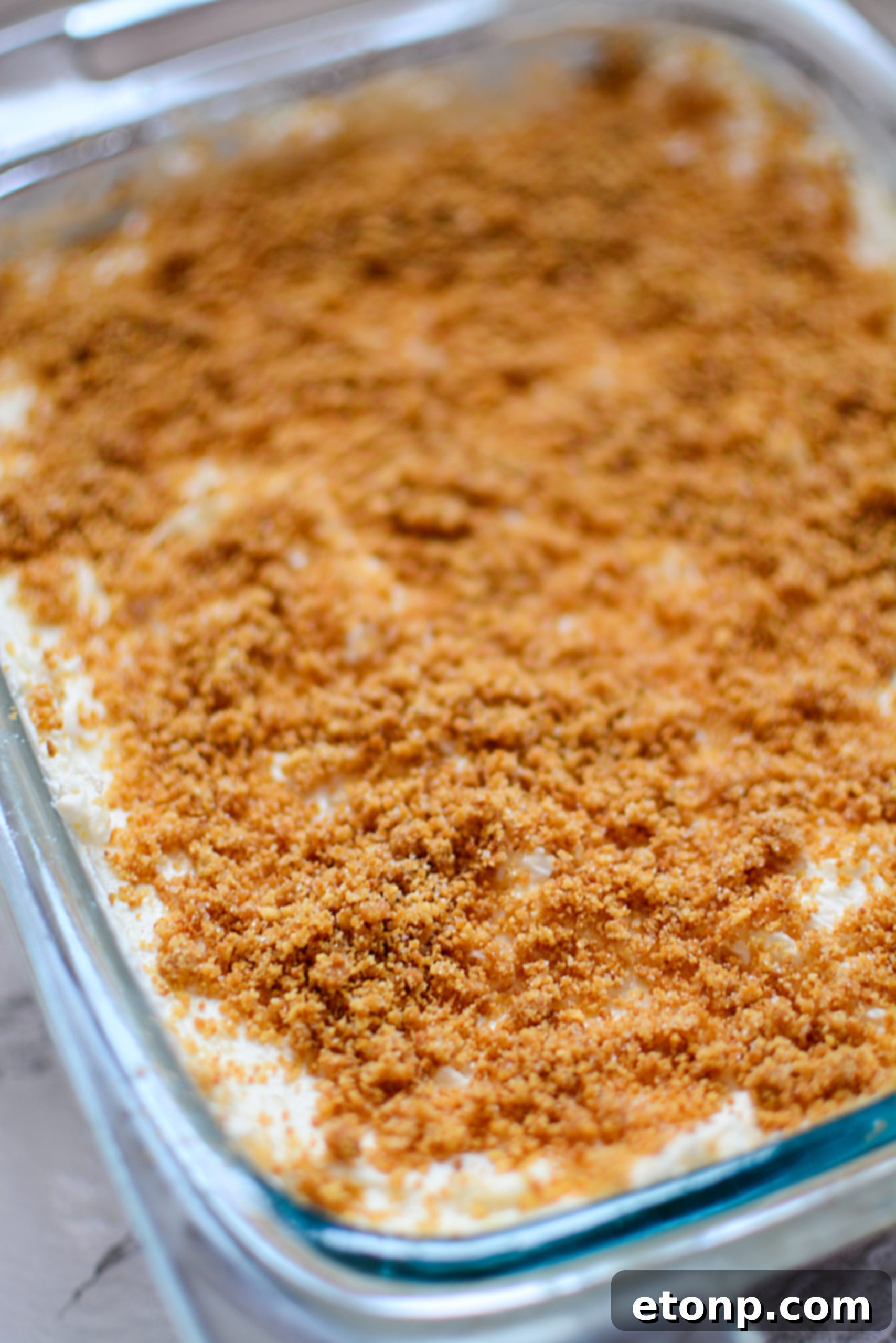 A spoonful of creamy pineapple dessert, showing its smooth texture.
