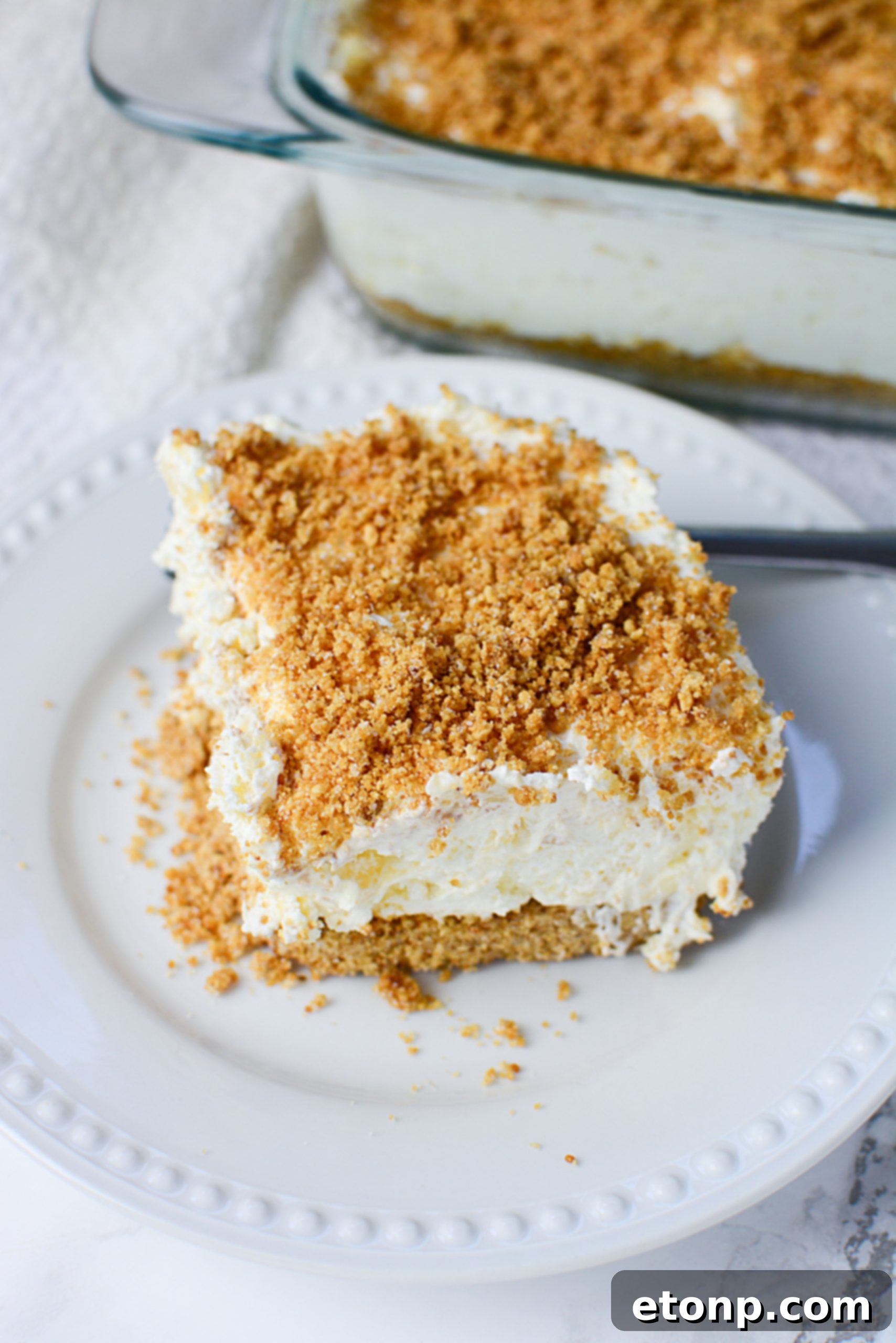 A full square pan of easy pineapple cream dessert, ready to be served.