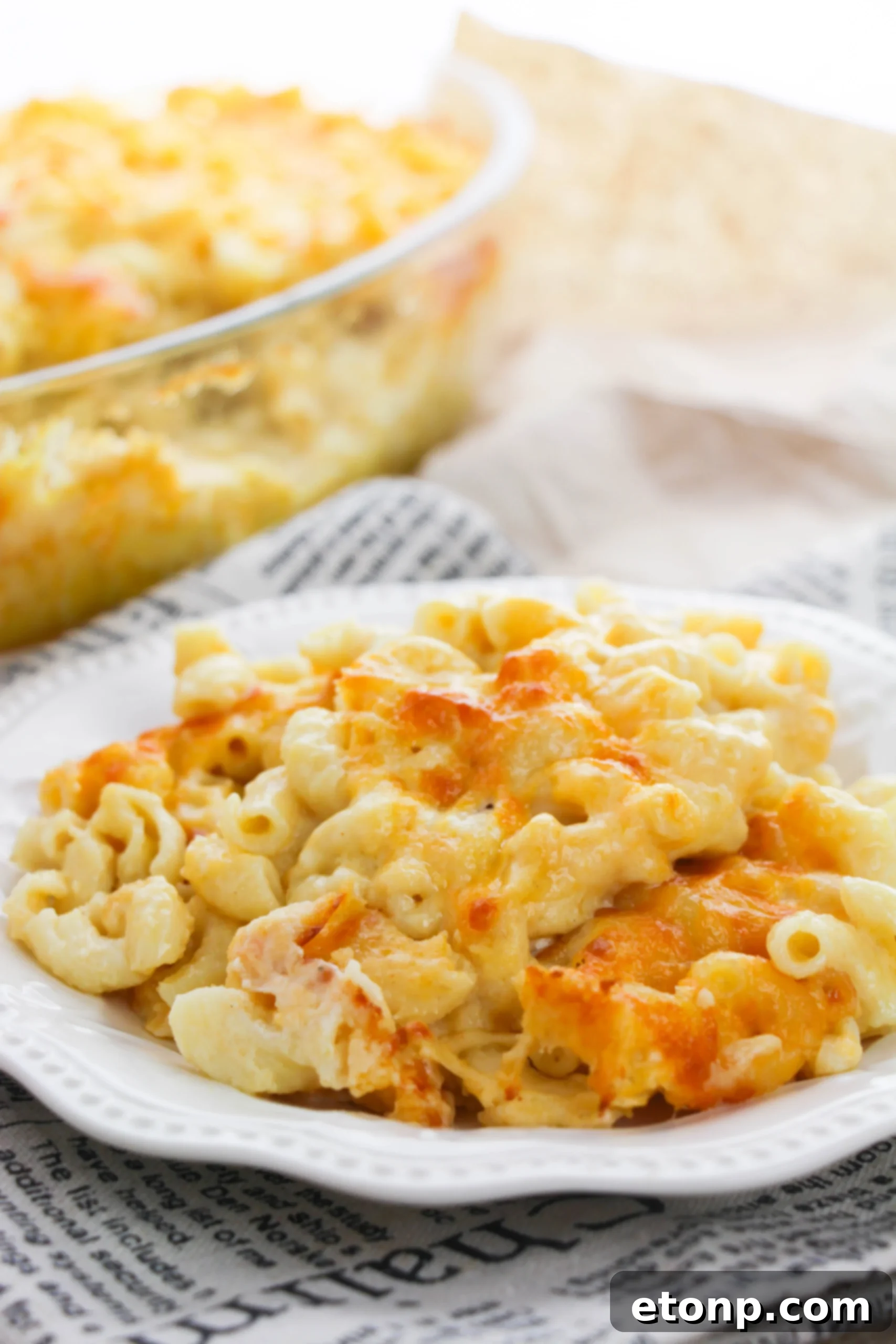 Macaroni and cheese with added ingredients like chopped ham or chicken, showing it as a complete meal.
