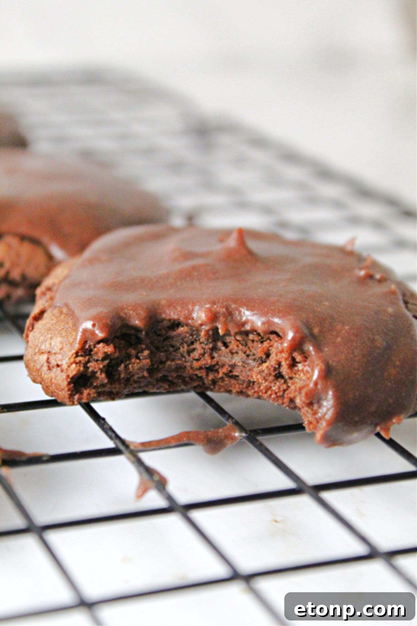 Close-up of a plate of Texas Sheet Cake Cookies with chocolate frosting, ready to be enjoyed.