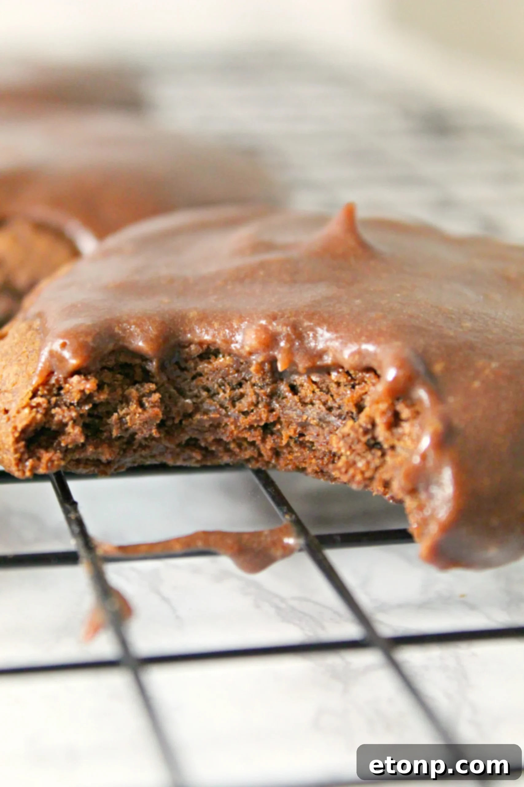 Several frosted Texas Sheet Cake Cookies arranged on a serving plate, inviting you to indulge.
