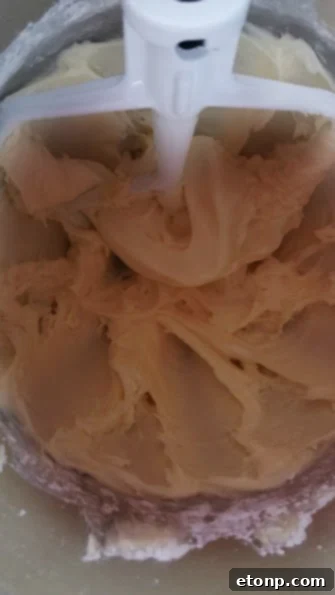 Close-up of a single red velvet cupcake, highlighting the rich red color and frosting texture