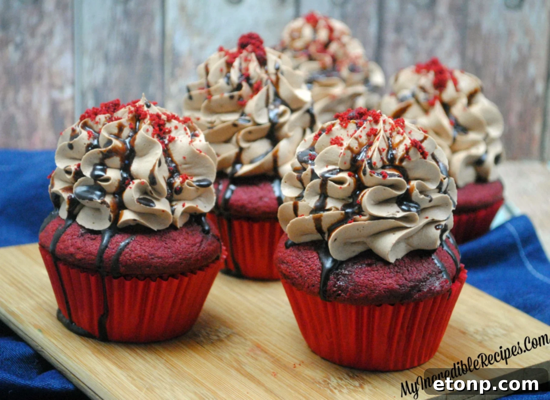 An artful arrangement of finished red velvet cupcakes, showcasing their vibrant colors and toppings