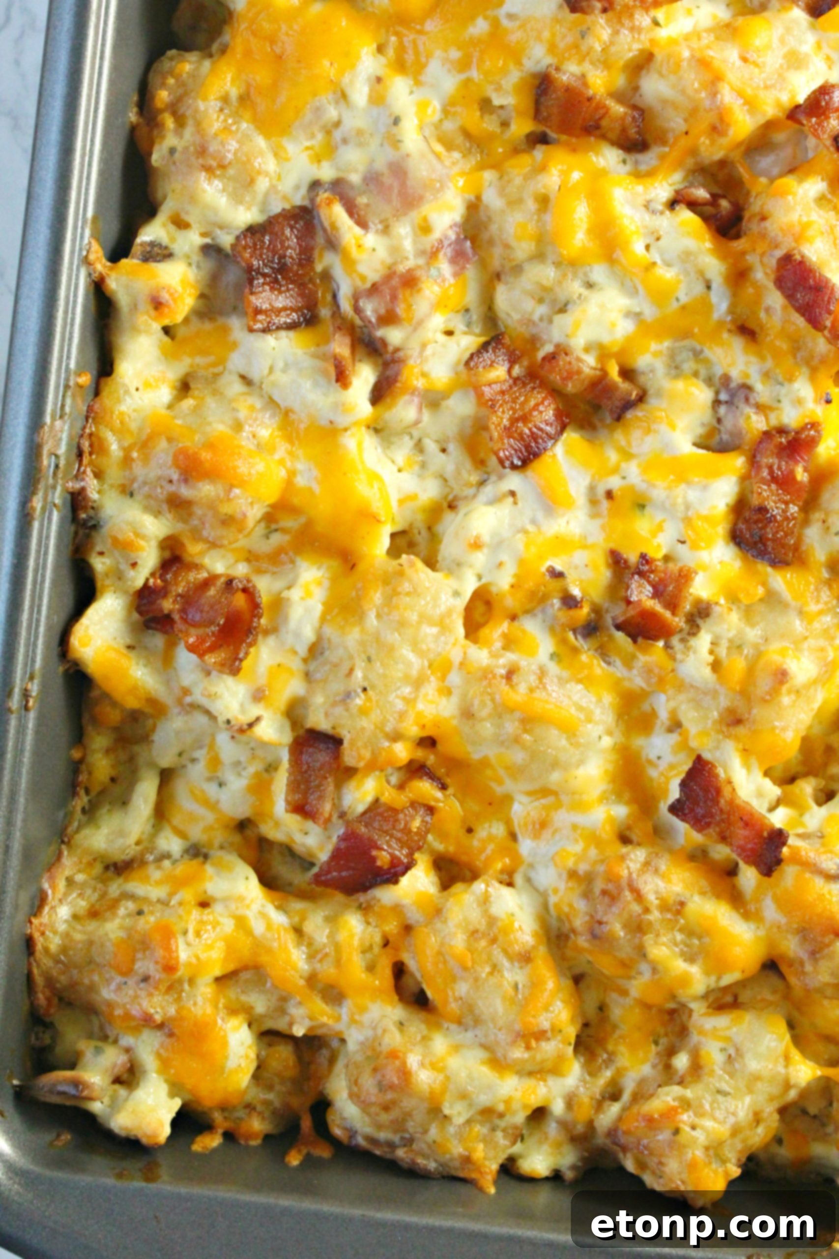 Crispy, chopped bacon, a key ingredient for adding smoky flavor and texture to the casserole.