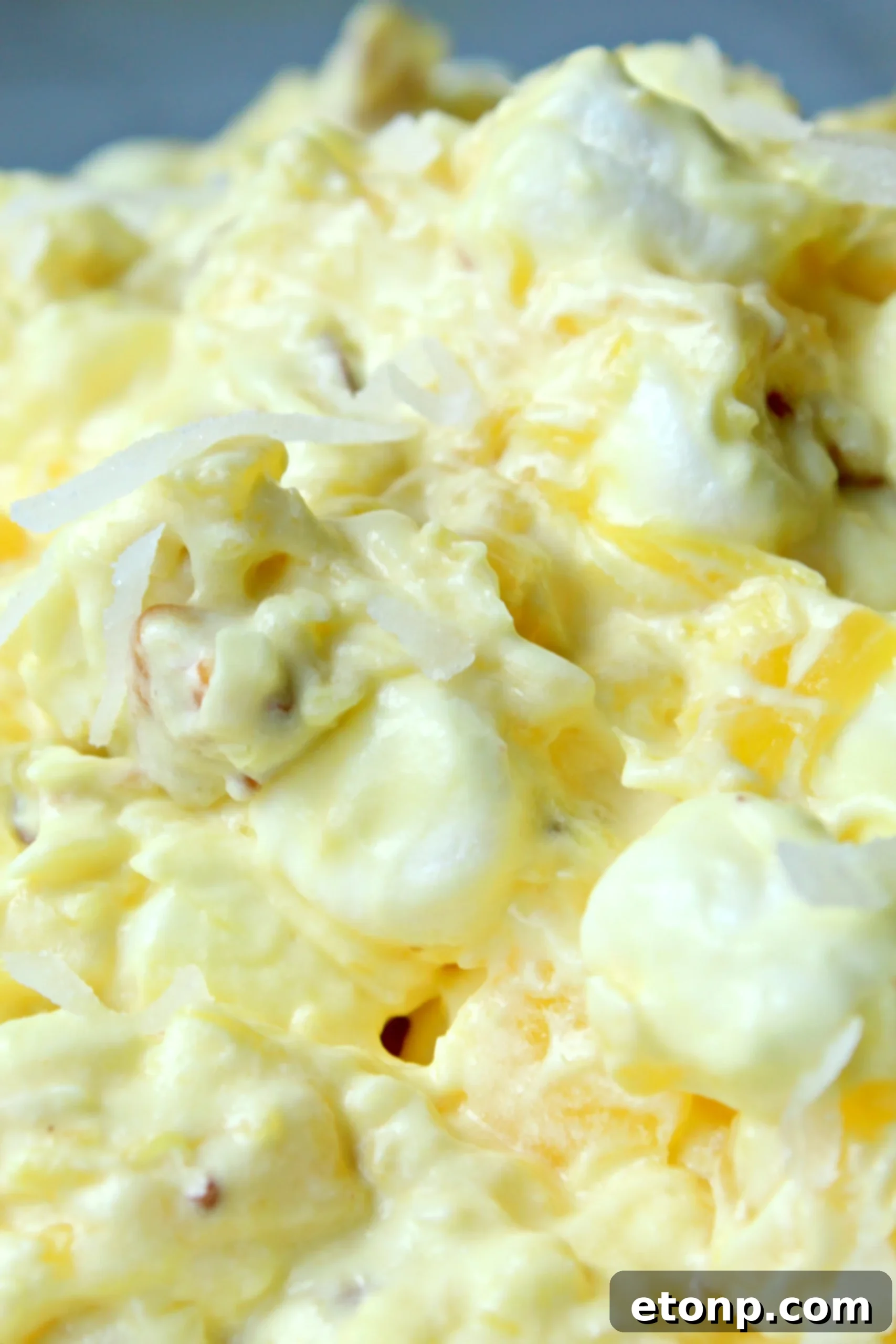 Pina Colada Fluff with a focus on its creamy, inviting appearance, hinting at the delightful flavors of pineapple and coconut.