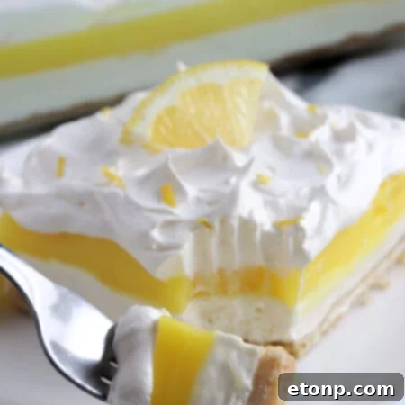 Lemon Lush Dessert slice on a plate.