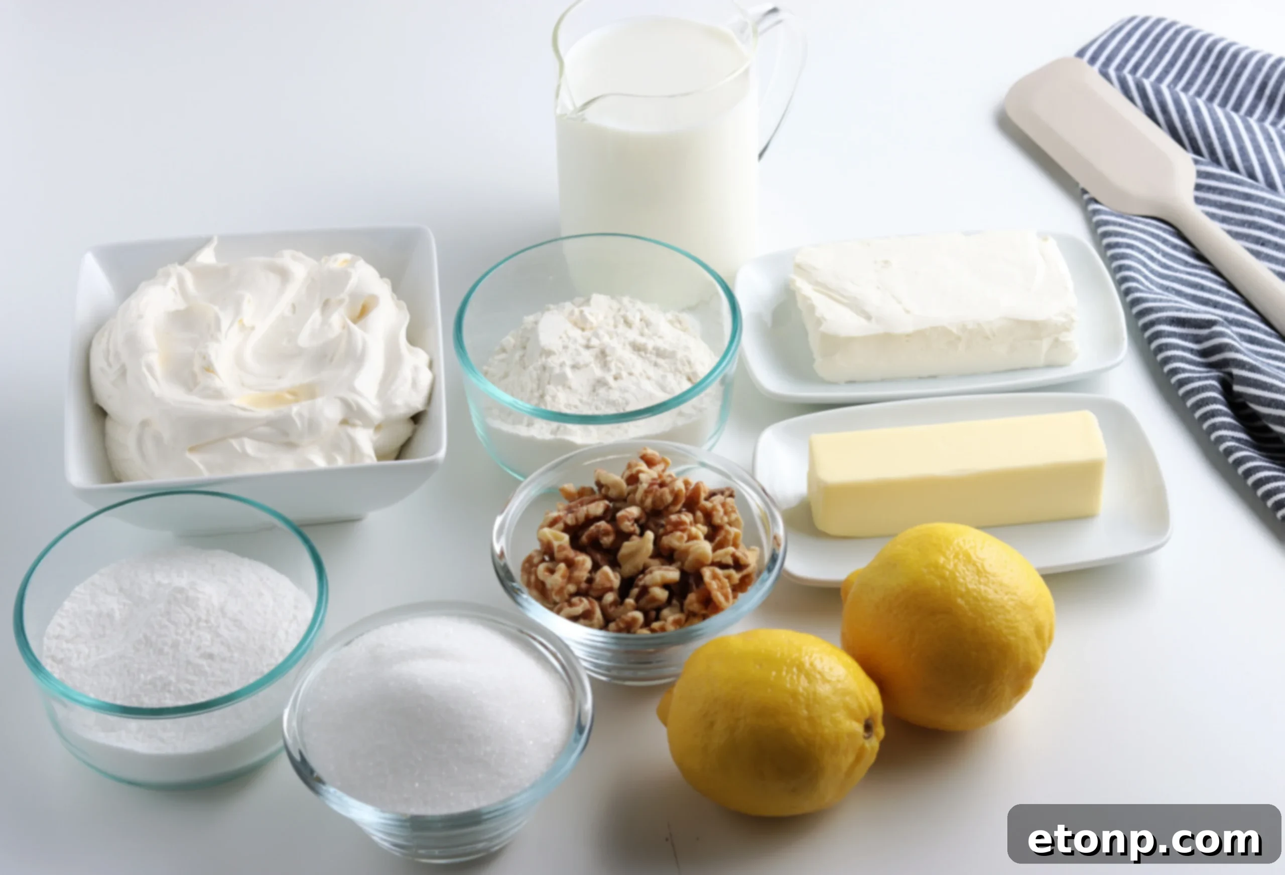 Overhead shot of a full pan of Lemon Lush Dessert, garnished with lemon slices and zest.