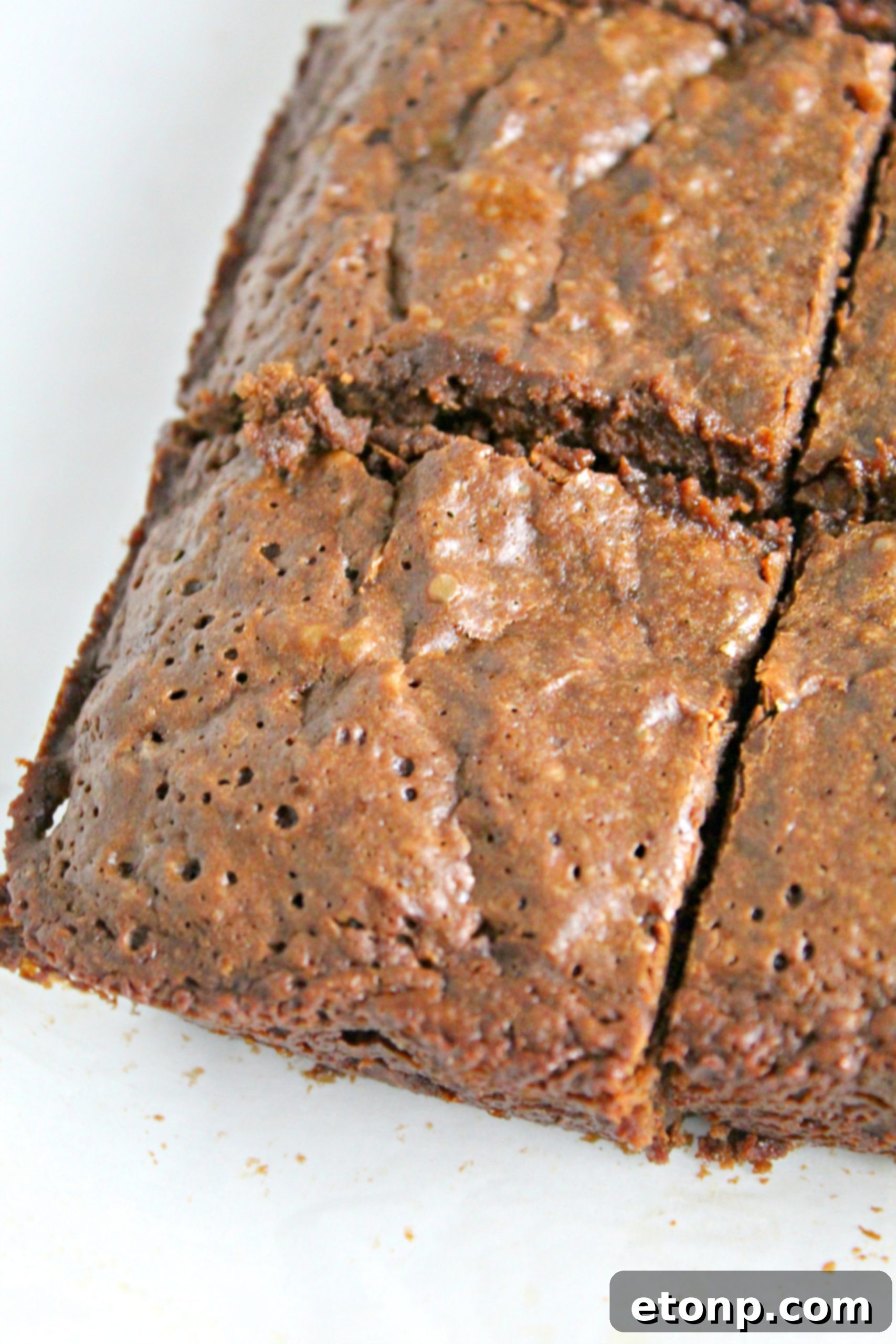 Decadent Dr Pepper Brownies 3 Side view of a batch of Dr. Pepper brownies cooling on a wire rack, showcasing their rich texture